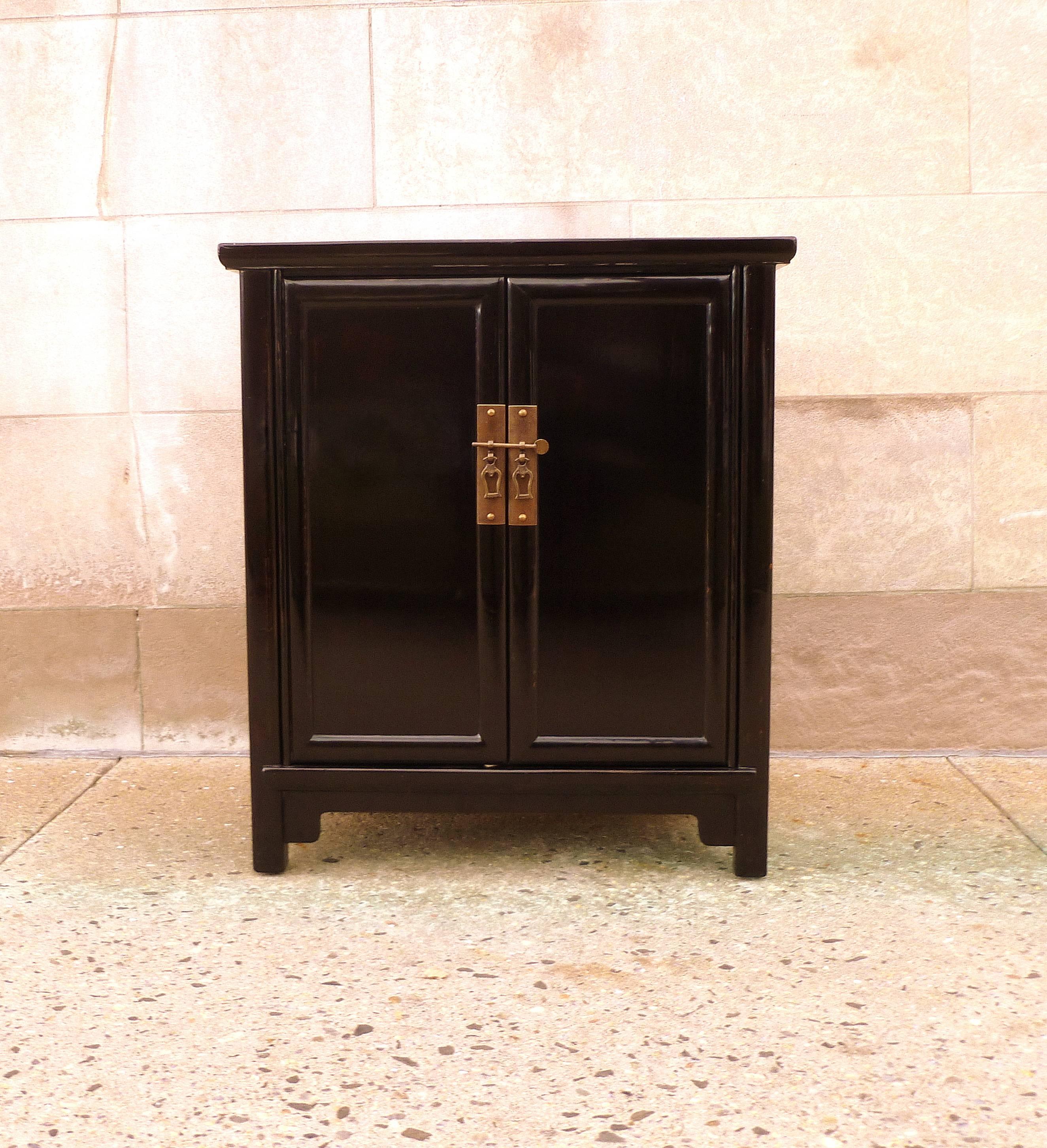 Fine black lacquer chest with pair of open doors and shelves inside. Elegant form and beautiful color.