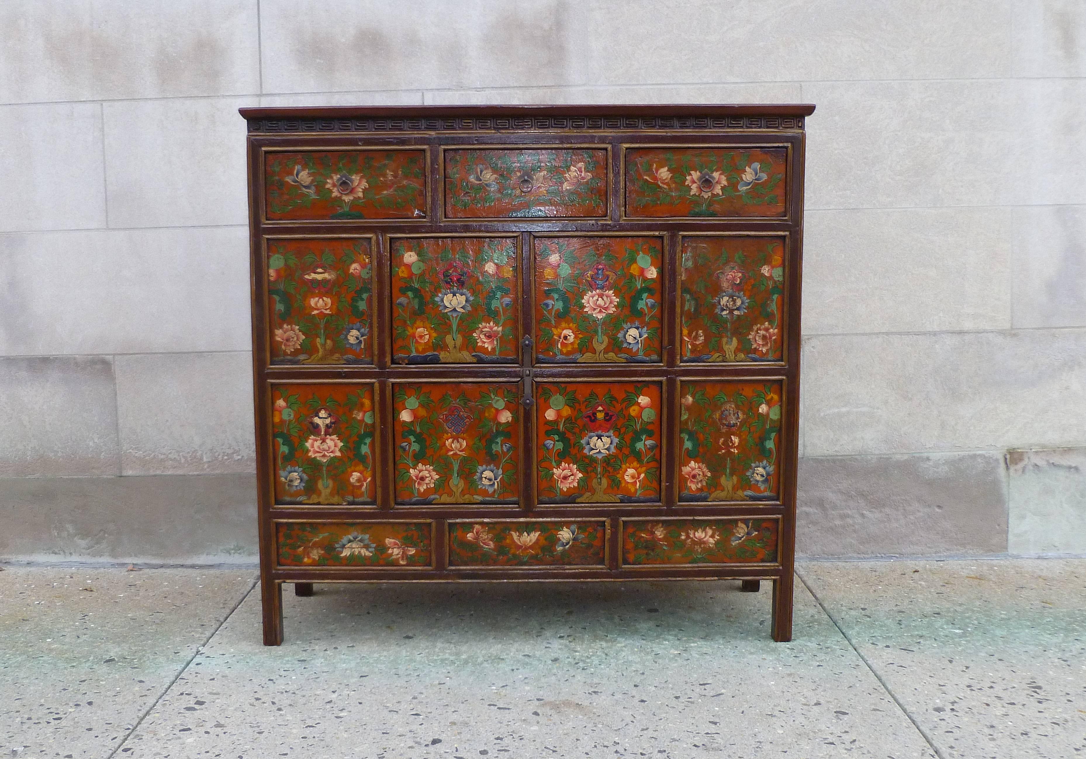Tibetan chest with beautiful hand-painted floral motif on the front side, two pairs of doors, simple form, elegant colors.