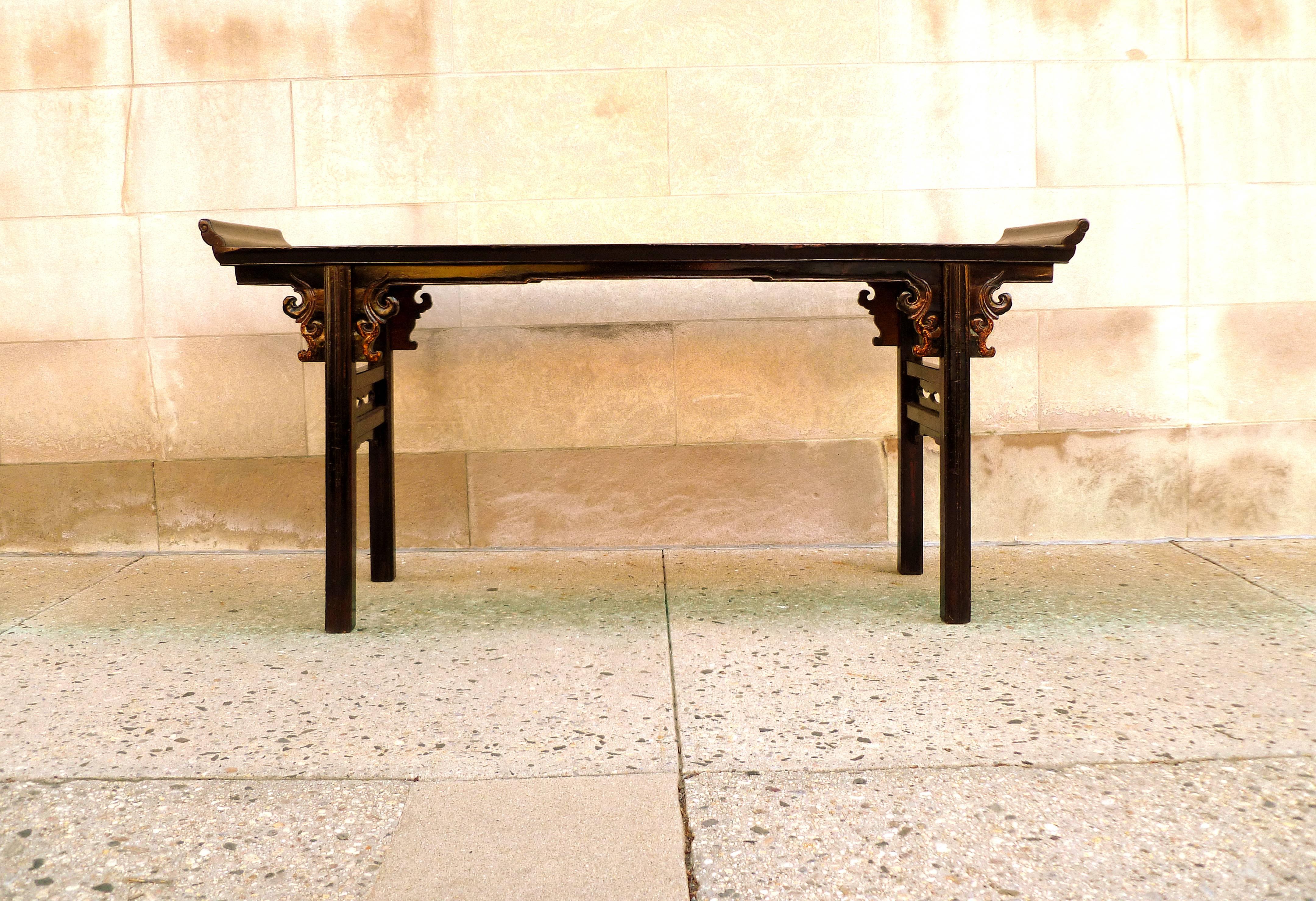 Black lacquer console table or altar table with carved spandrels. Nice detail.