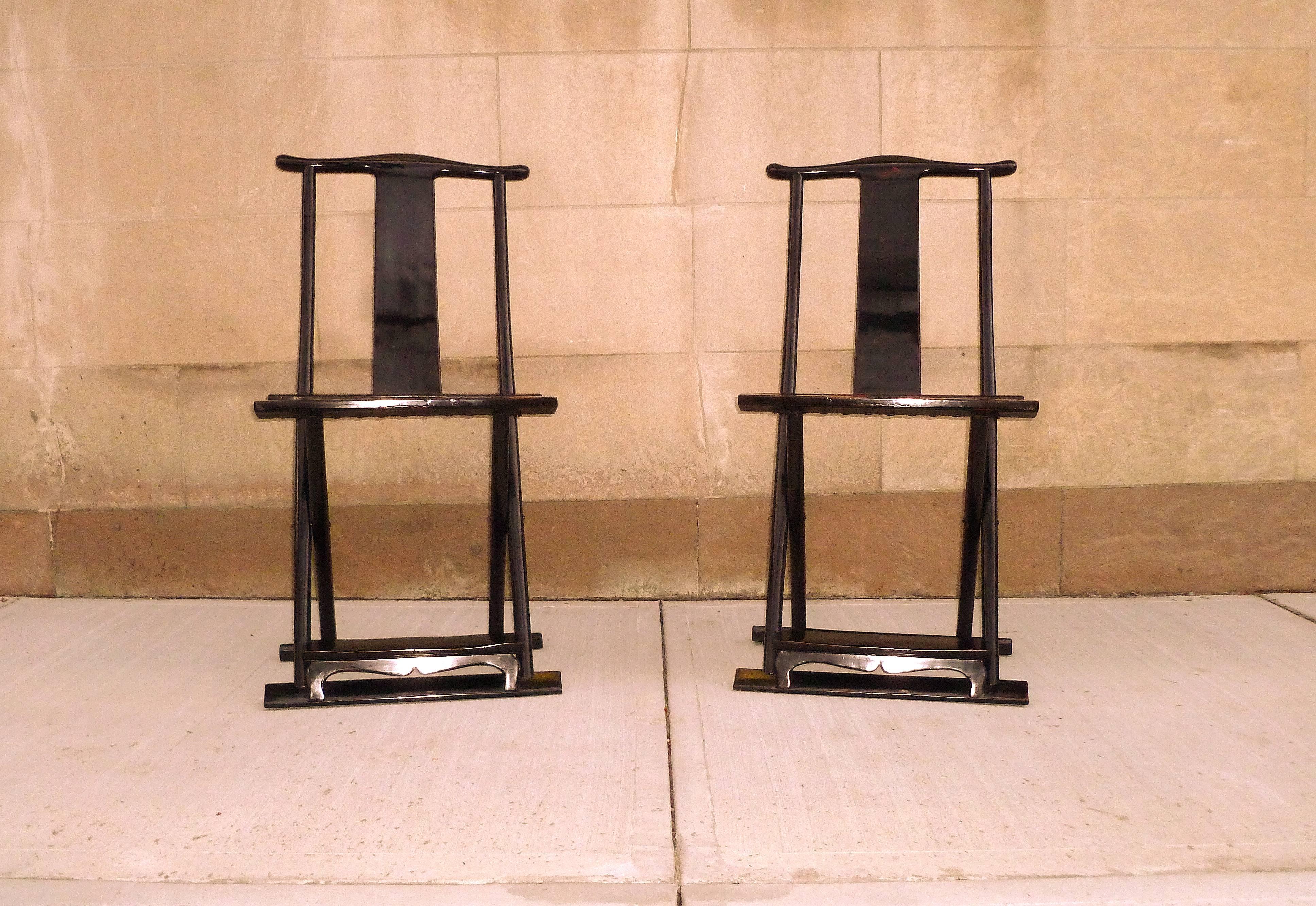 Pair of black lacquer folding chairs. Simple and elegant black lacquer folding chairs, beautiful form and lines.
