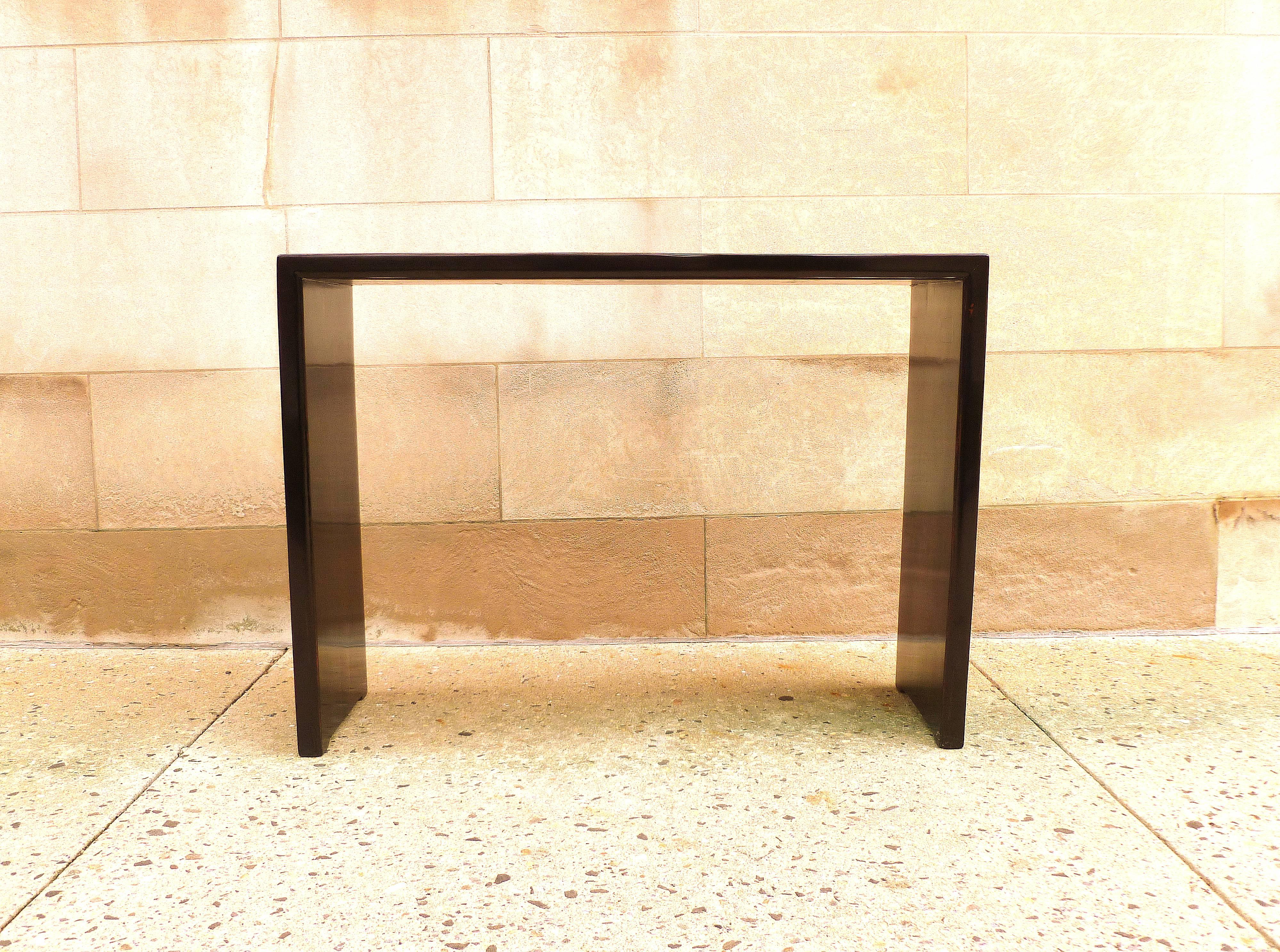 Simple black lacquer console table with waterfall legs, elegant color and lines.  We carry fine quality furniture with elegant finished and has been appeared many times in 