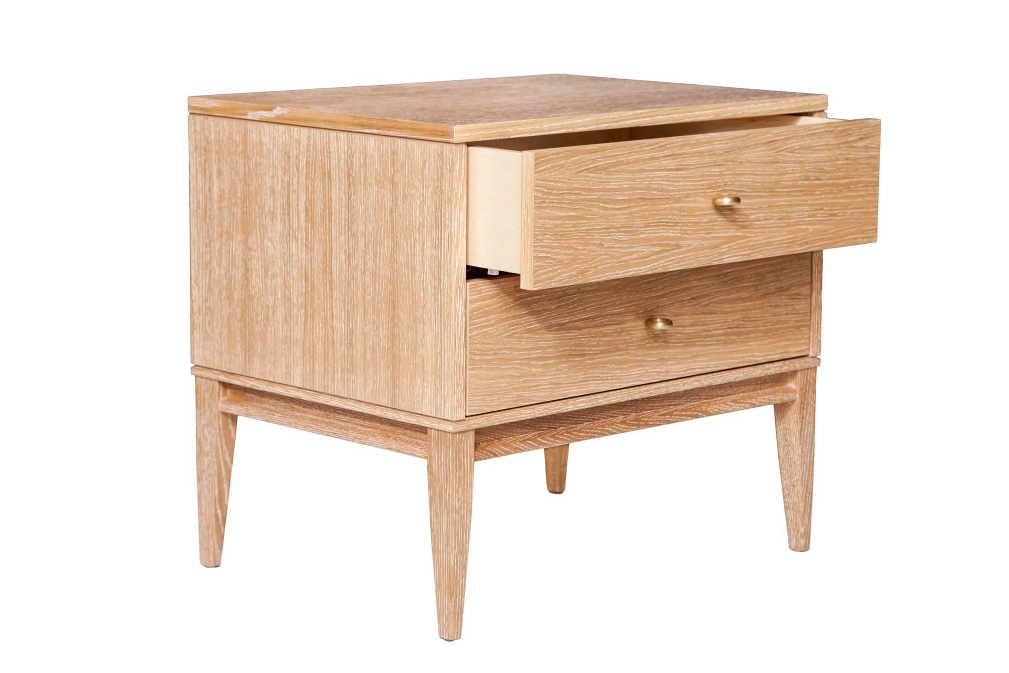 Cerused oak two-drawer nightstands on apron frame base detailed with solid brass drawer pulls. Solid maple drawer boxes with under-mount soft close mechanical drawer slides.
Custom lacquer and wood finishes available. 

Custom orders have a lead
