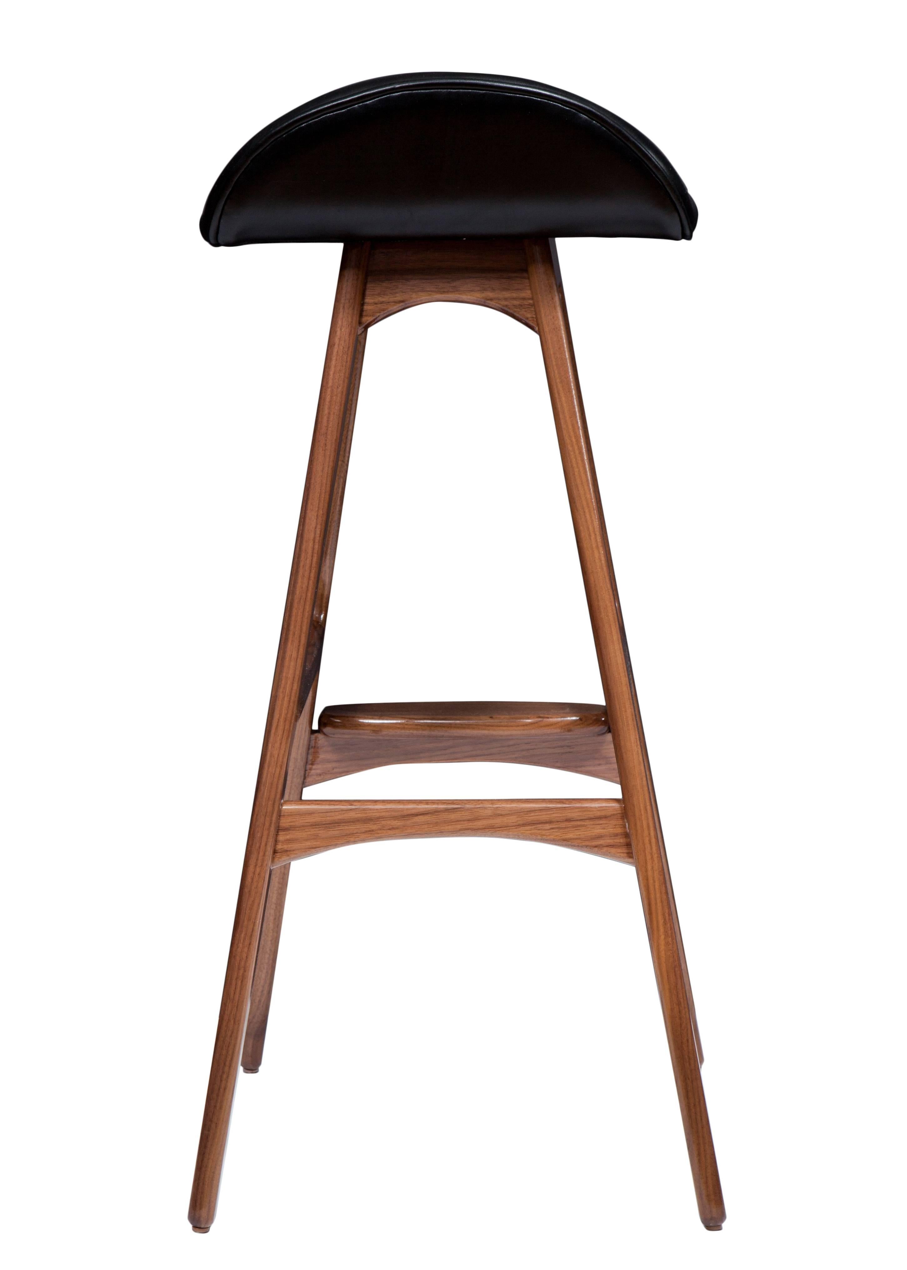 Boyd counter stool shown in solid walnut with black leather seat.