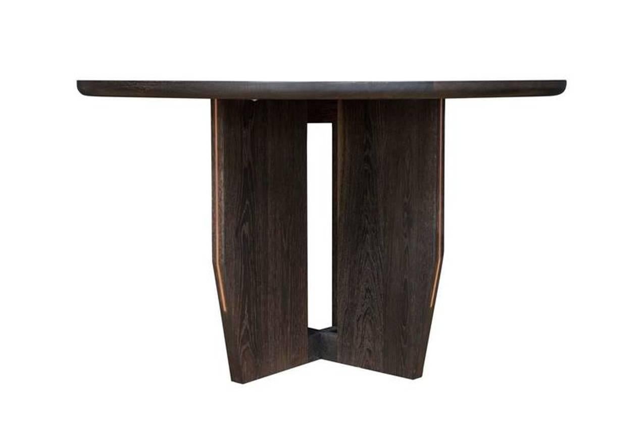 Round fumed oak dining table.
Designed by Paul Mignogna for Stillmade.

