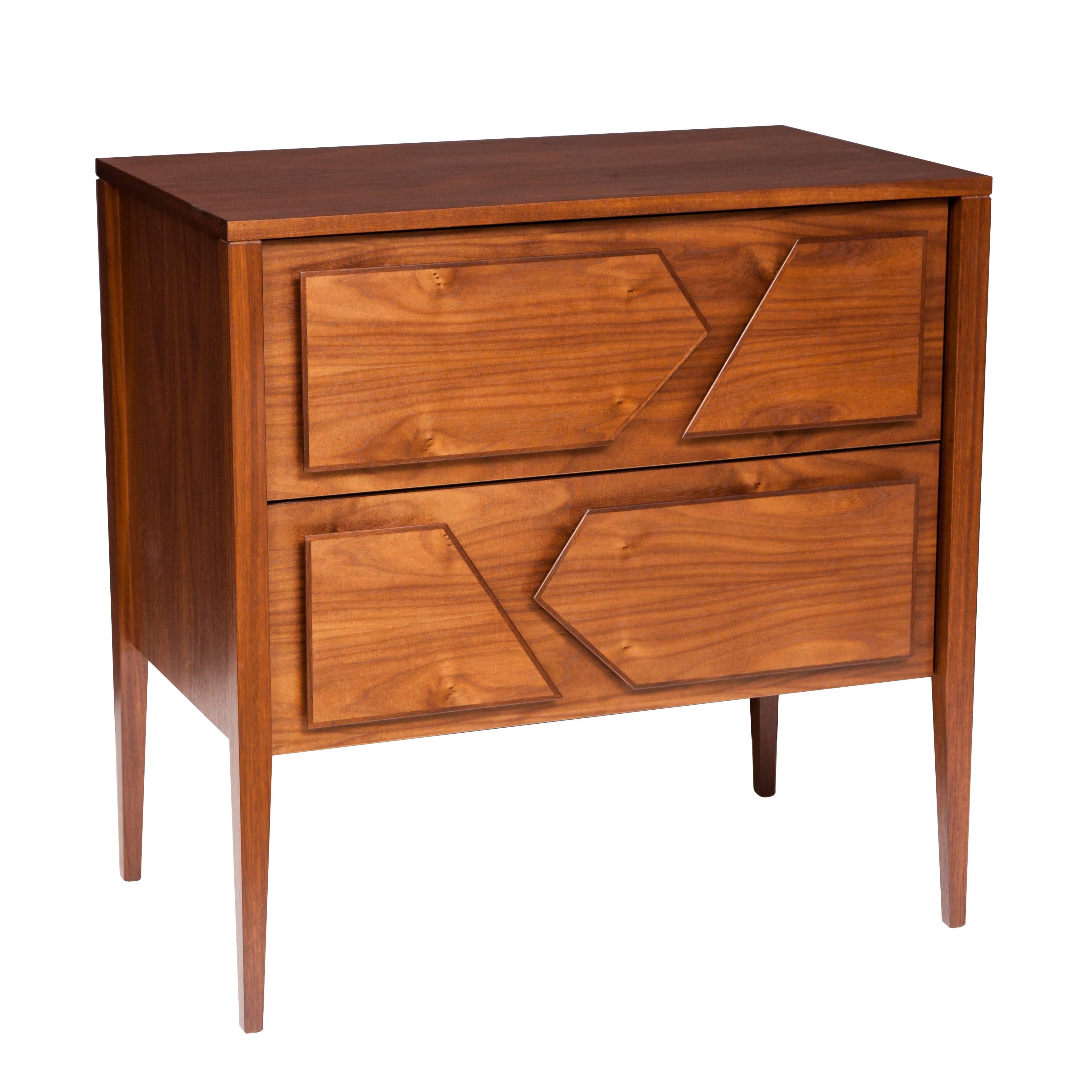 Armia two drawer walnut dresser featuring raised paneled shapes trimmed in solid walnut that act as drawer pulls and provide a 3D graphic detail. 

Custom orders have a lead time of 10-12 weeks FOB NYC. Lead time contingent upon selection of