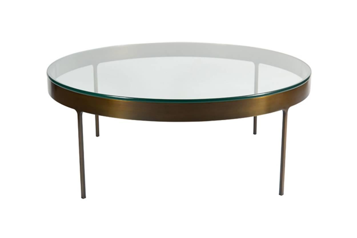 Bronze ring cocktail table with fitted clear glass top. Solid flat bar metal frame with on thin profile legs with interior radius joint detail.

Custom orders have a lead time of 10-12 weeks FOB NYC. Lead time contingent upon selection of