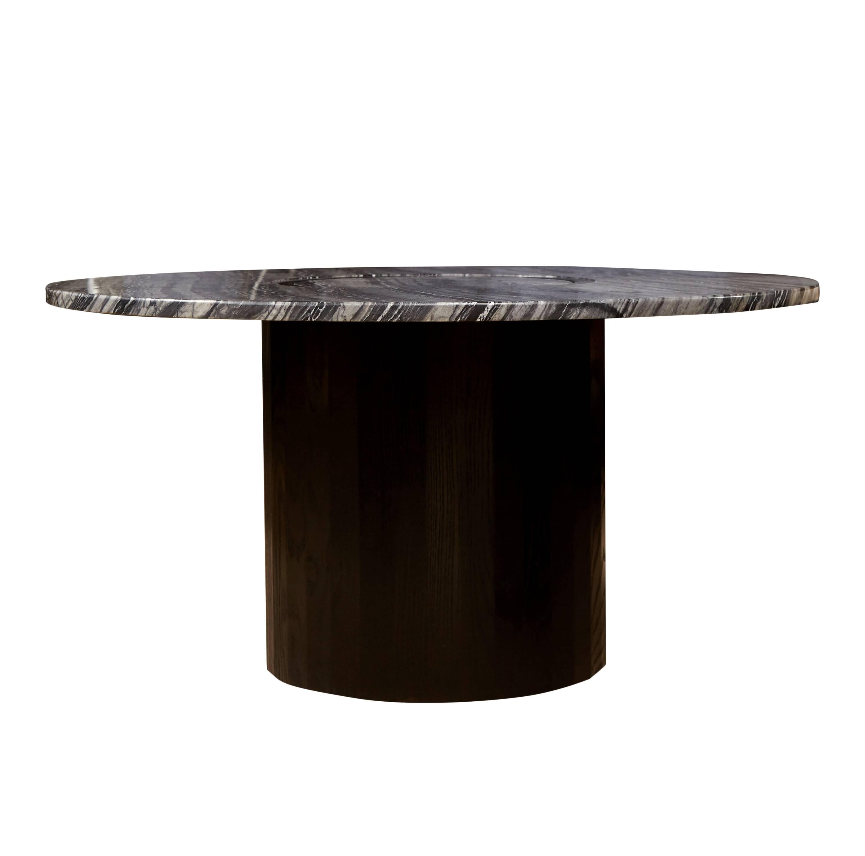 The Bastet coffee table is made from blackened ash coopered together with grain matched detailing. Marble sits flush on the faceted base as the stones layers wander across the surface. Dimensions, finish and stone are customizable to