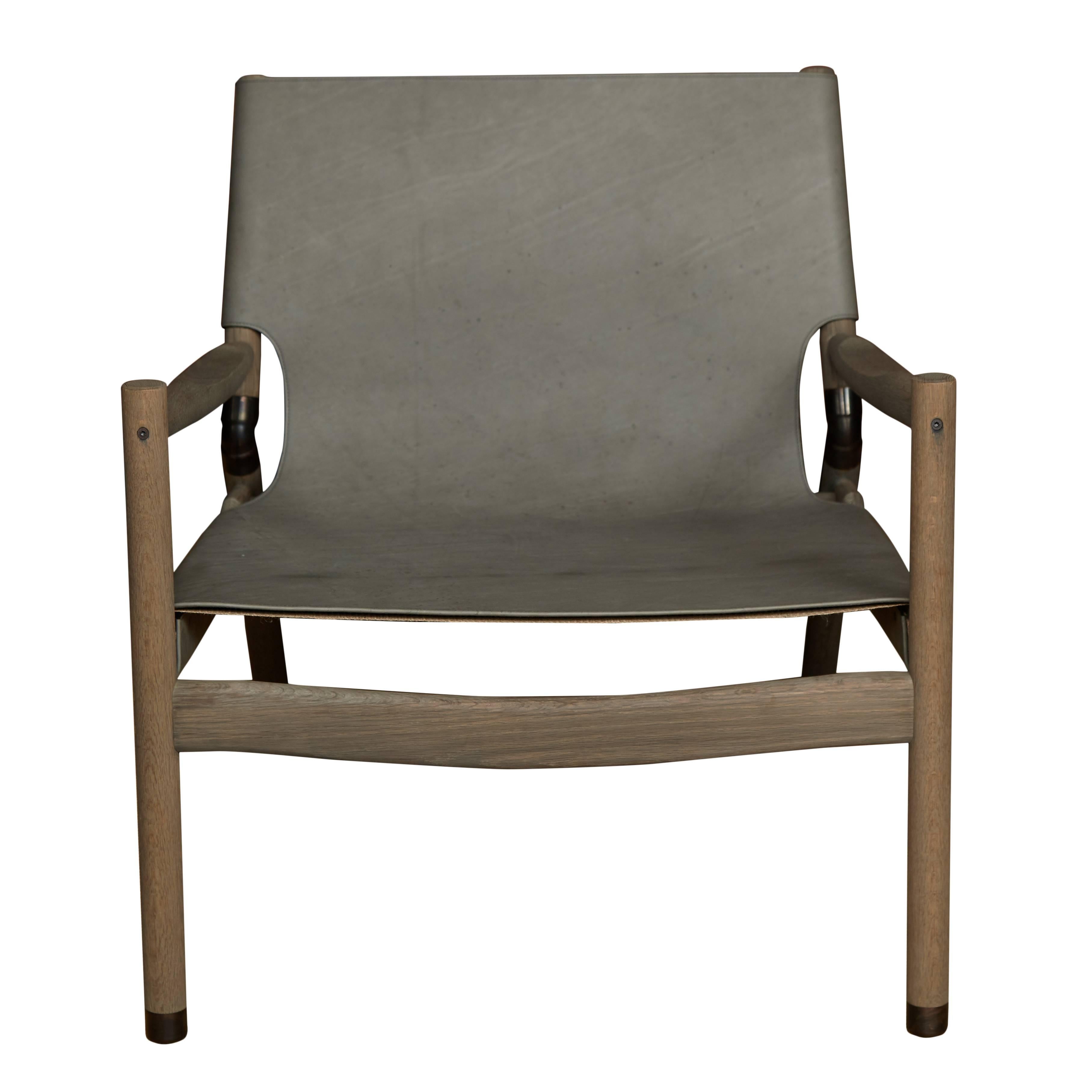 Erickson aesthetics slung leather greyed oak lounge chair.
Seat height-15” 
Custom orders have a lead time of 10-12 weeks FOB NYC. Lead time contingent upon selection of finishes, approval of shop drawings (if applicable), and receipt COM (if