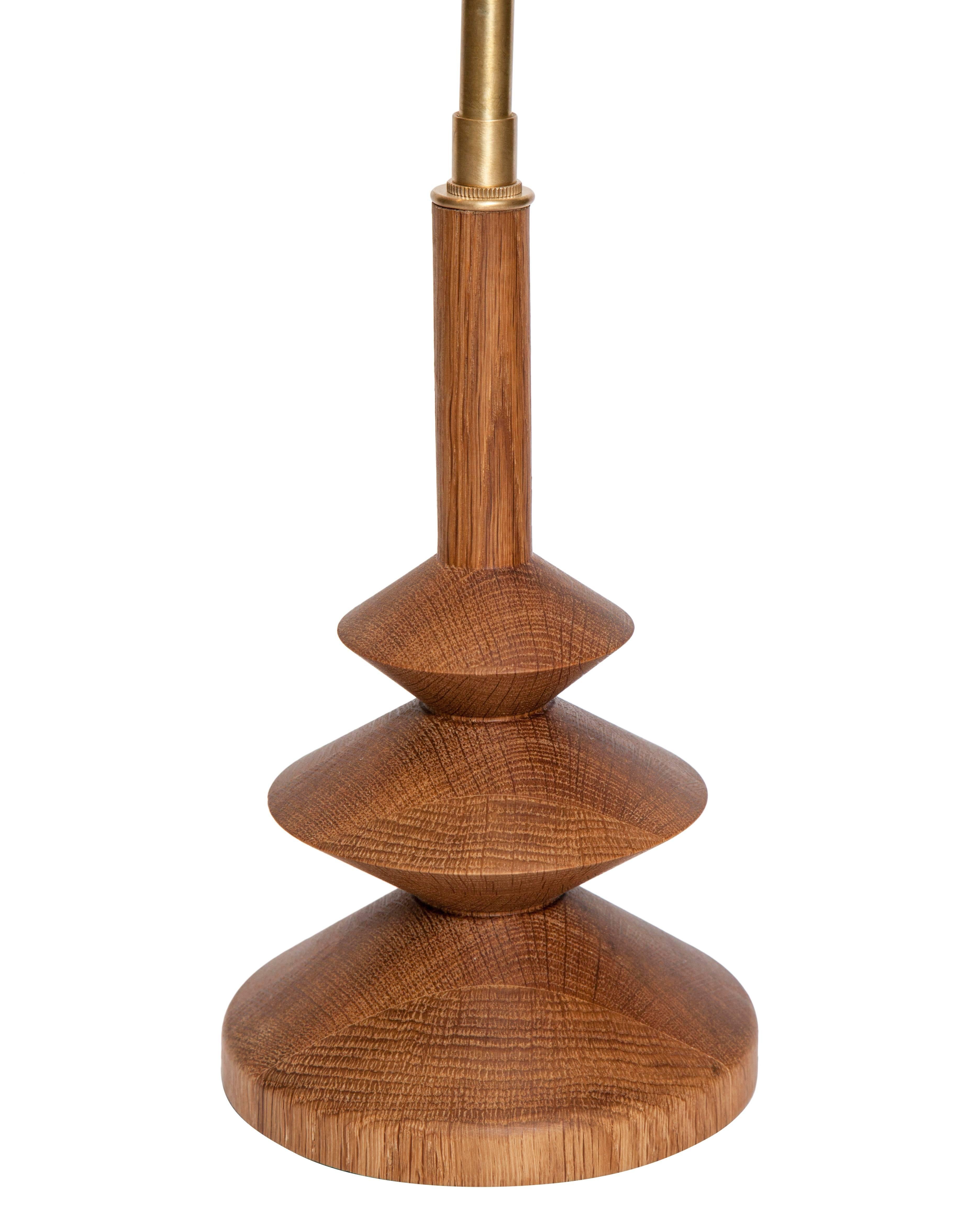Solid turned oak table lamp with bronze stem double cluster adjustable height shade fixture.
Other woods and finishes available.
Wood base height-9