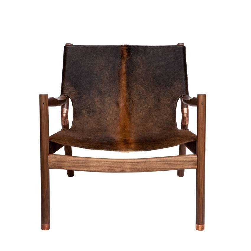 Slung Brindle walnut lounge chair with copper sabots and joint connectors.
Designed by Ben Erickson for  Erickson Aesthetics.

Seat height-12