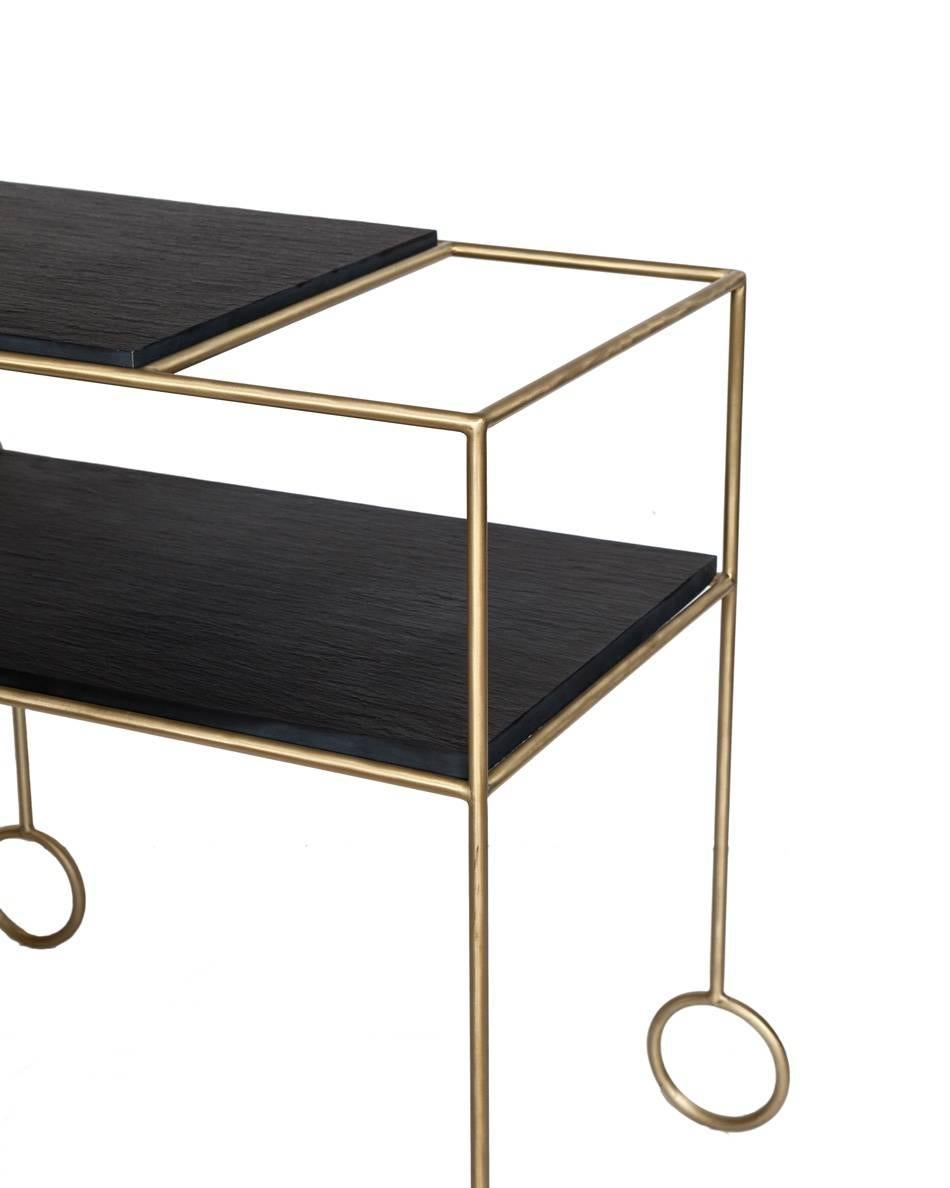 Biron satin brass frame bar cart with natural cleft finish slate tops. 

Custom orders have a lead time of 10-12 weeks FOB NYC. Lead time contingent upon selection of finishes, approval of shop drawings (if applicable) and receipt COM (if