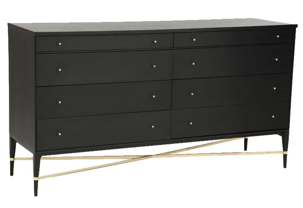 Paul McCobb Calvin eight-drawer dresser for directional, circa 1950s. Finely constructed modernist dresser from mahogany with solid brass X cross stretcher detail and original drawer hardware. Fully restored in ebonized mahogany.