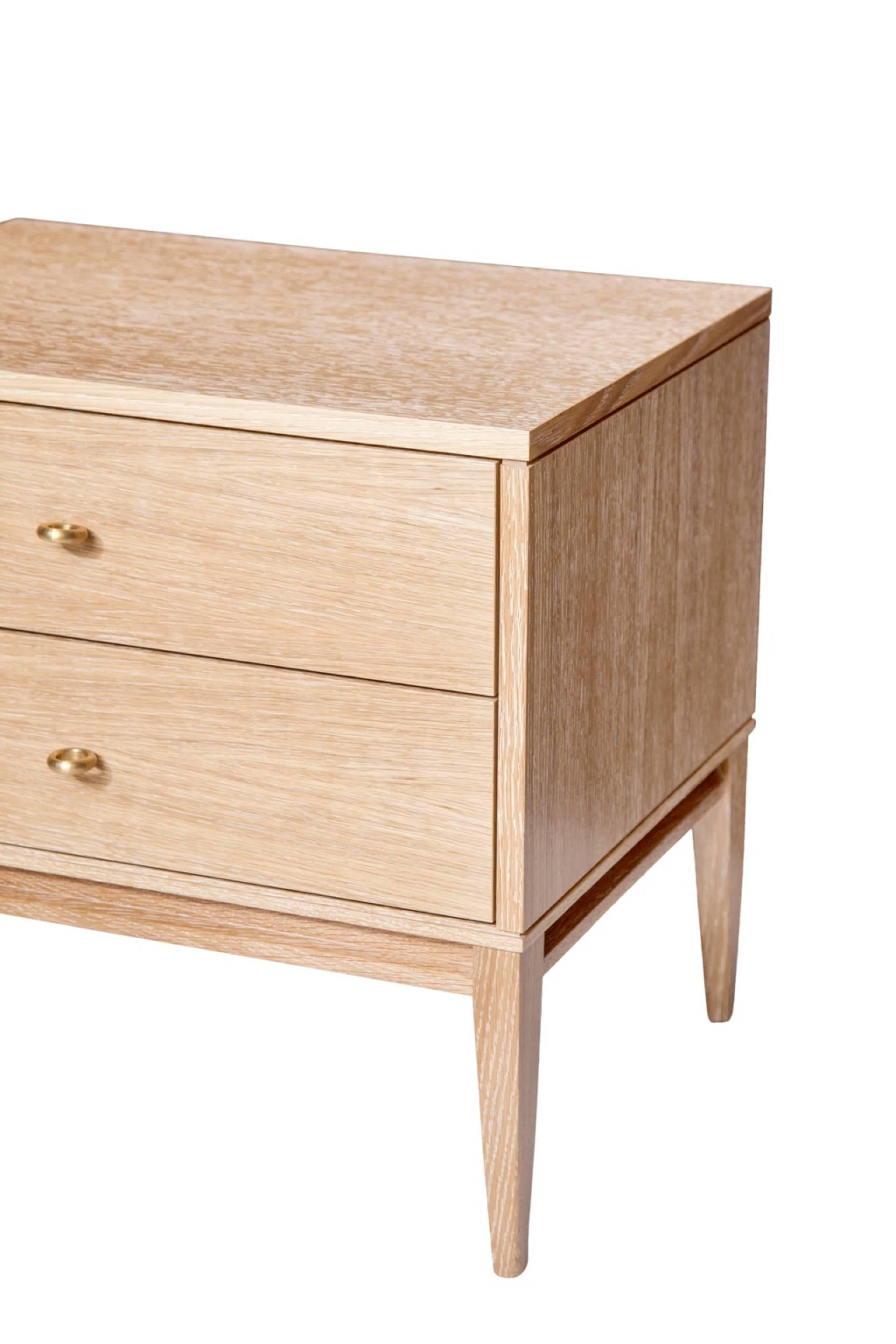 Cerused oak two-drawer nightstands on apron frame base detailed with solid brass drawer pulls. Solid maple drawer boxes with under-mount soft close mechanical drawer slides.
Custom lacquer and wood finishes available.

Custom orders have a lead