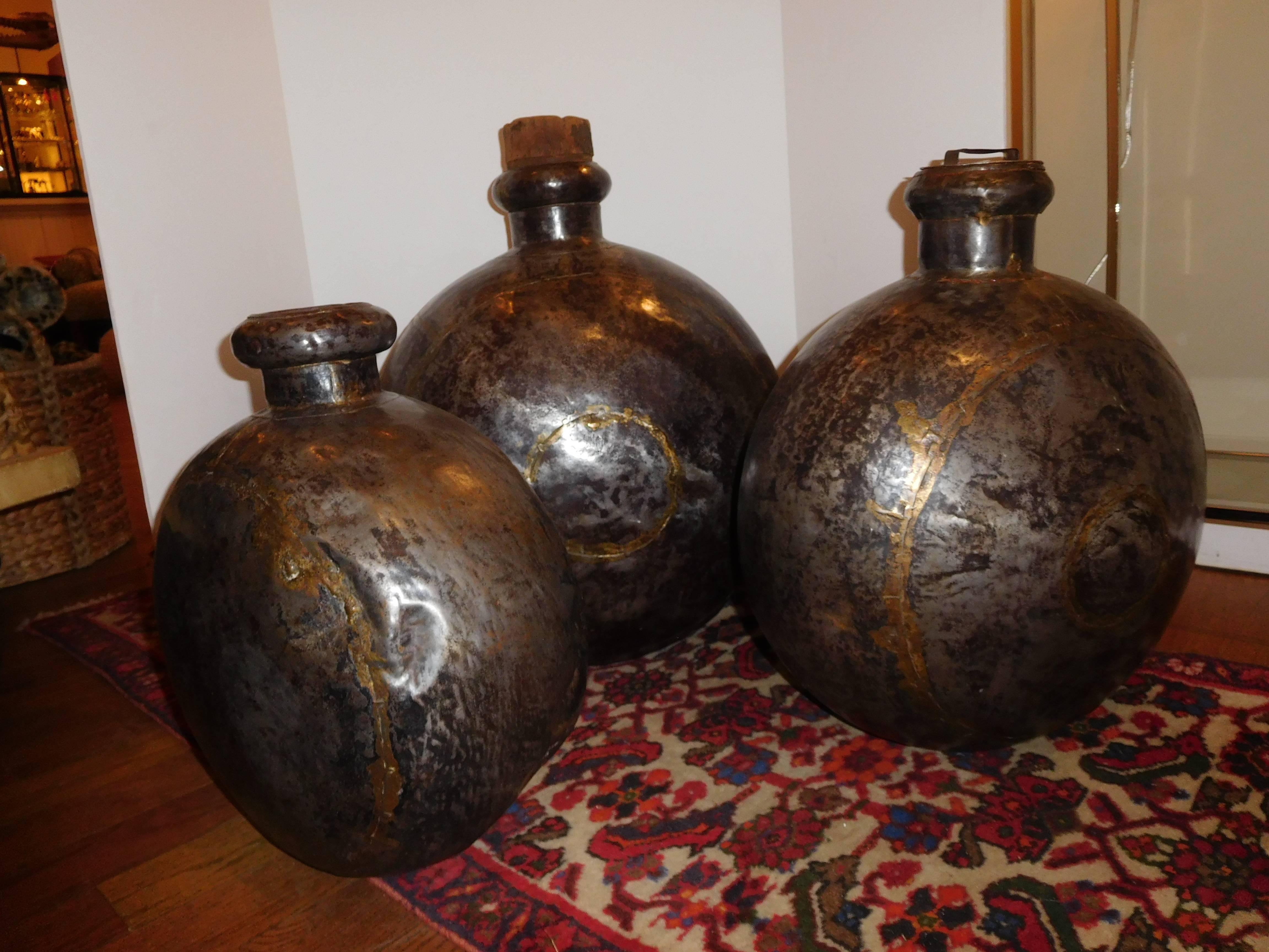 The three sizes are 26 inches high, 21 inches high and 18 inches high. The largest measurement is listed below. The tree copper vessels have a wonderful natural patina. One top is original (copper handle) one is cork and the other is without, some