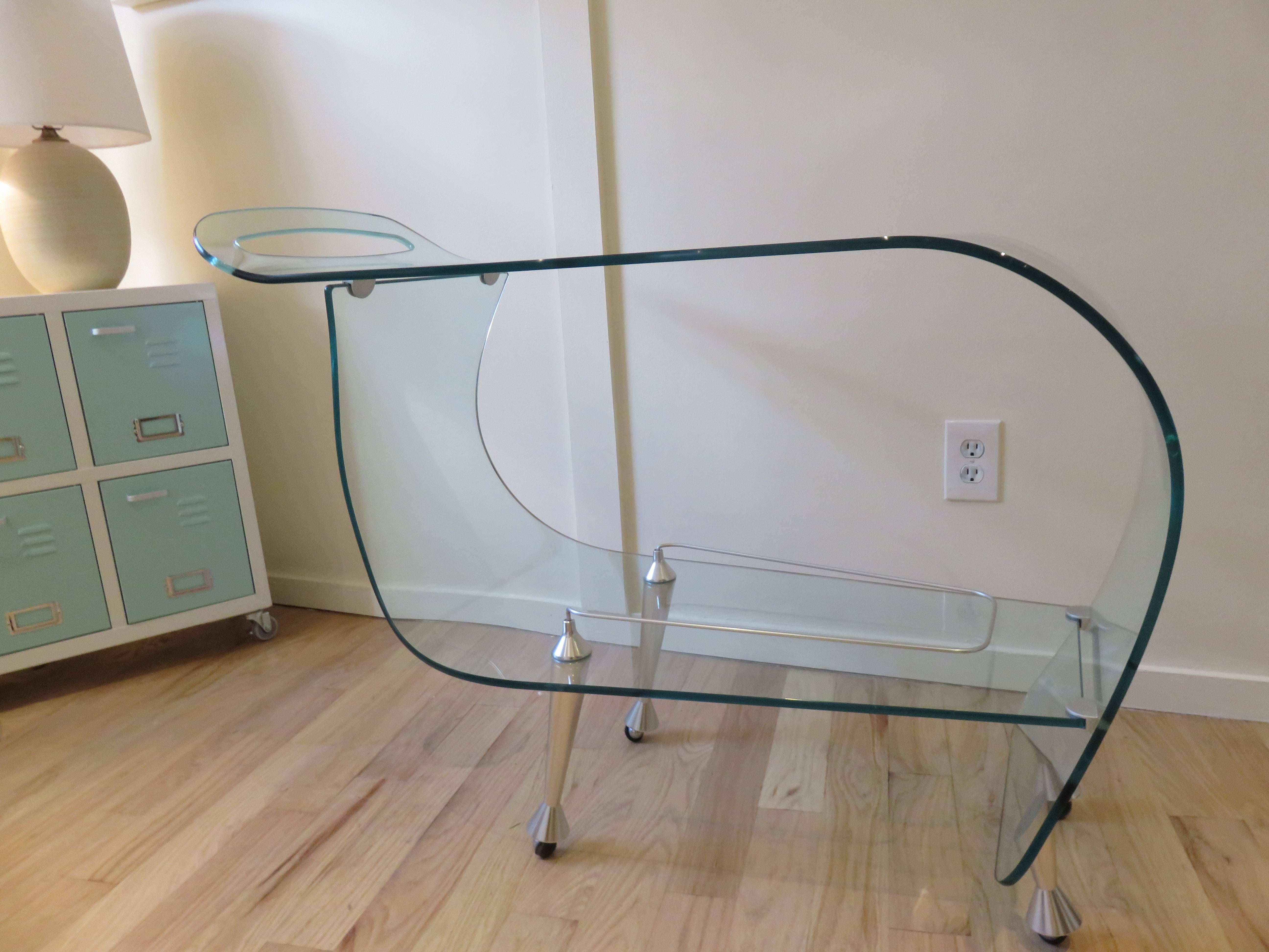 From the ghost collection a Fiam Italia glass bar cart/trolley sleek modern and fabulous in design,hand and industrial made.Brushed steel feet on casters.
Immaculate condition.