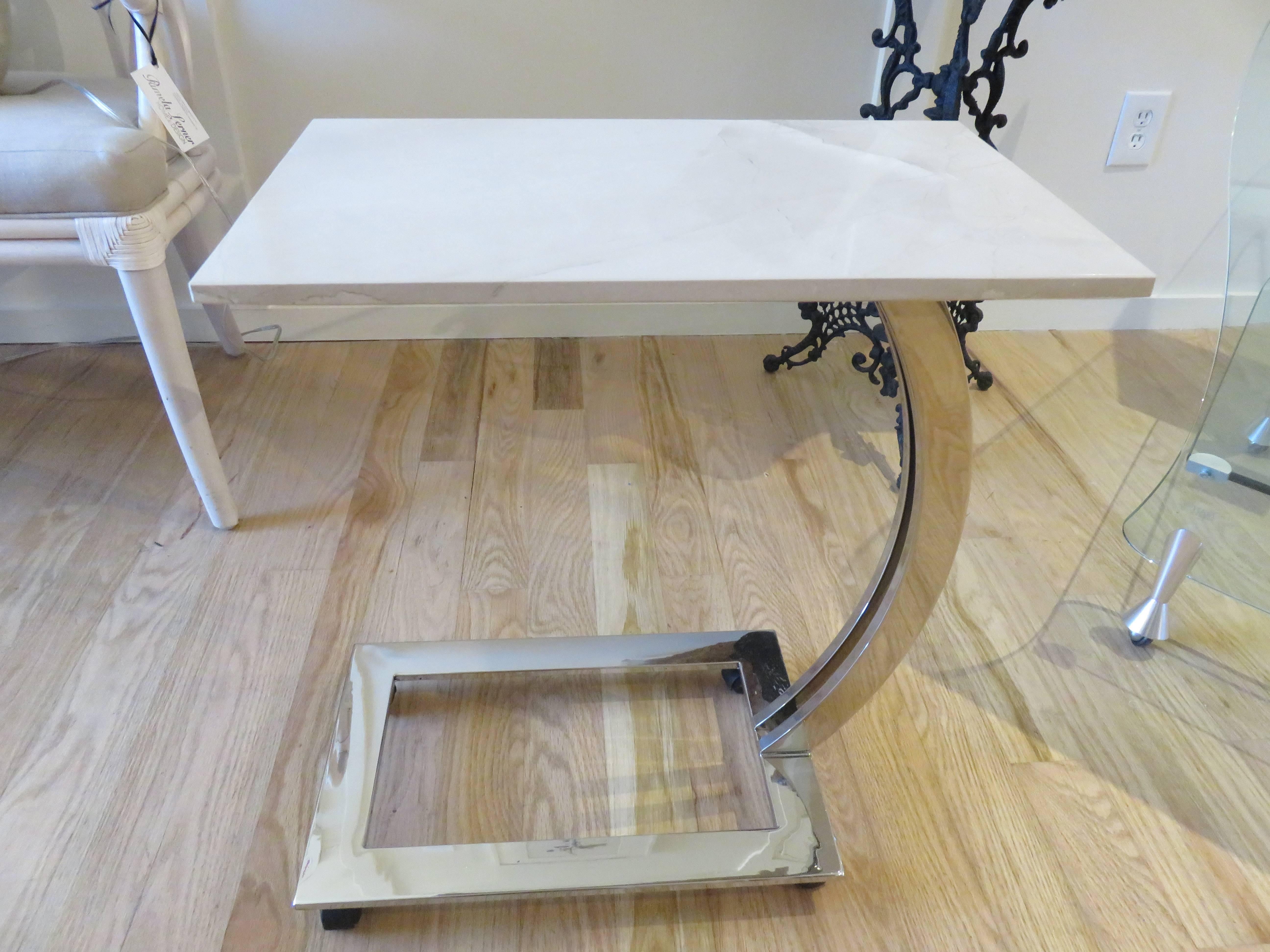 Pair of white marble and chrome side/end tables from Italy. Polished chrome base with casters ,and Carrara white marble tops. Works as both end tables or tray tables.