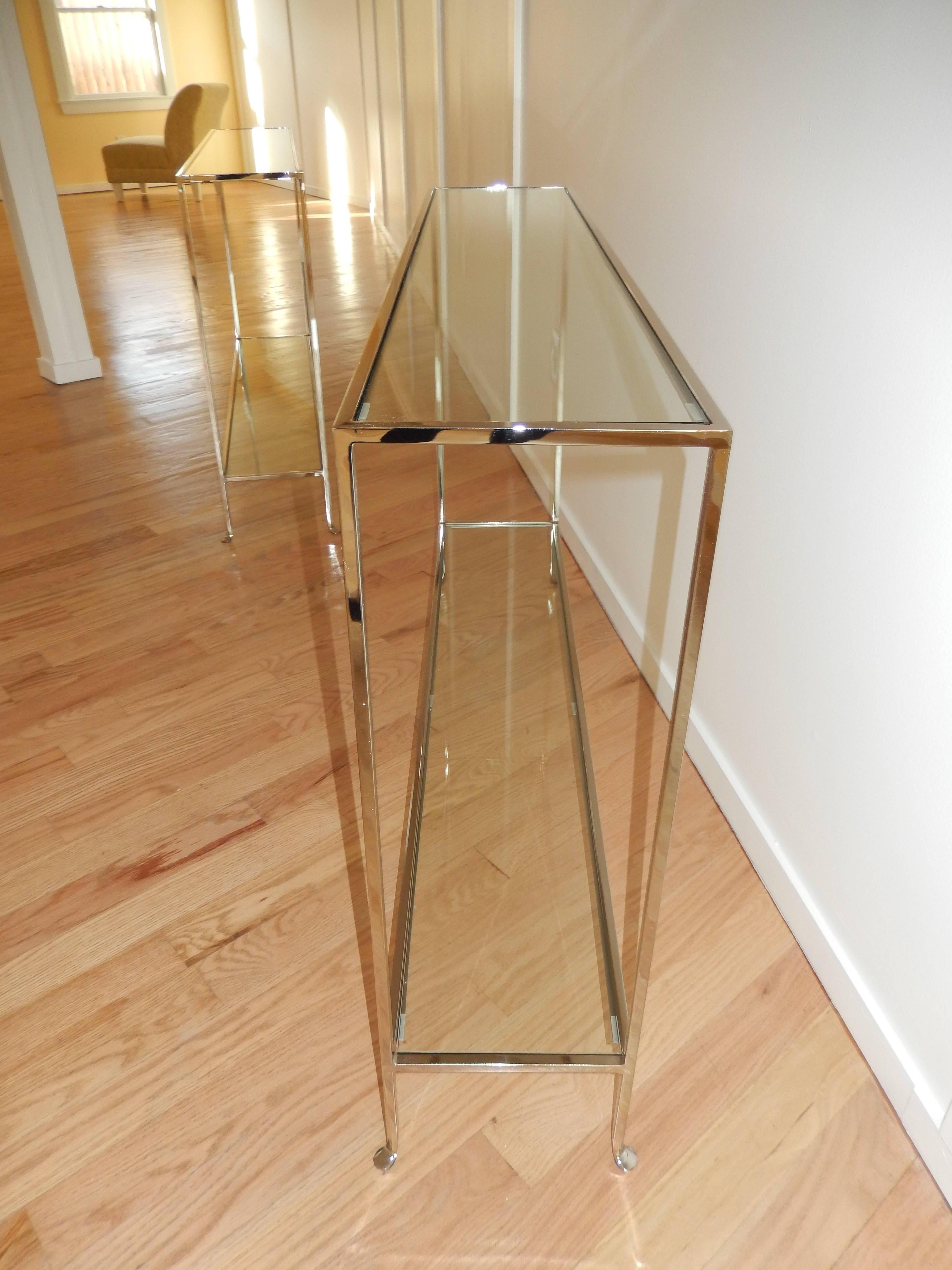 An Italian made nickel and glass slim line console table.This console  fits just about any where with a depth of 10 inches,works well in both traditional and contemporary settings.