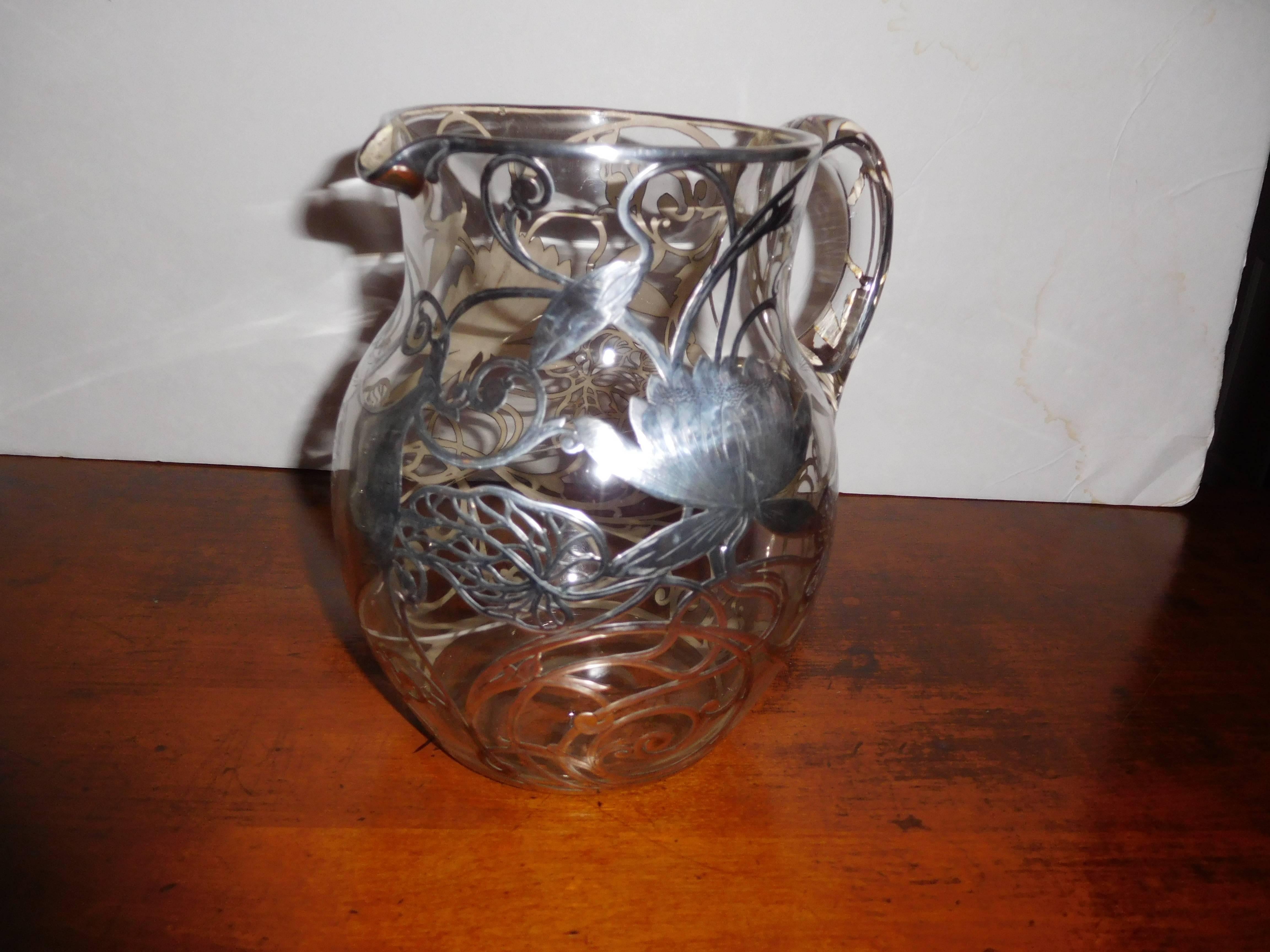 A truly beautiful sterling silver overlay on crystal vase or pitcher.