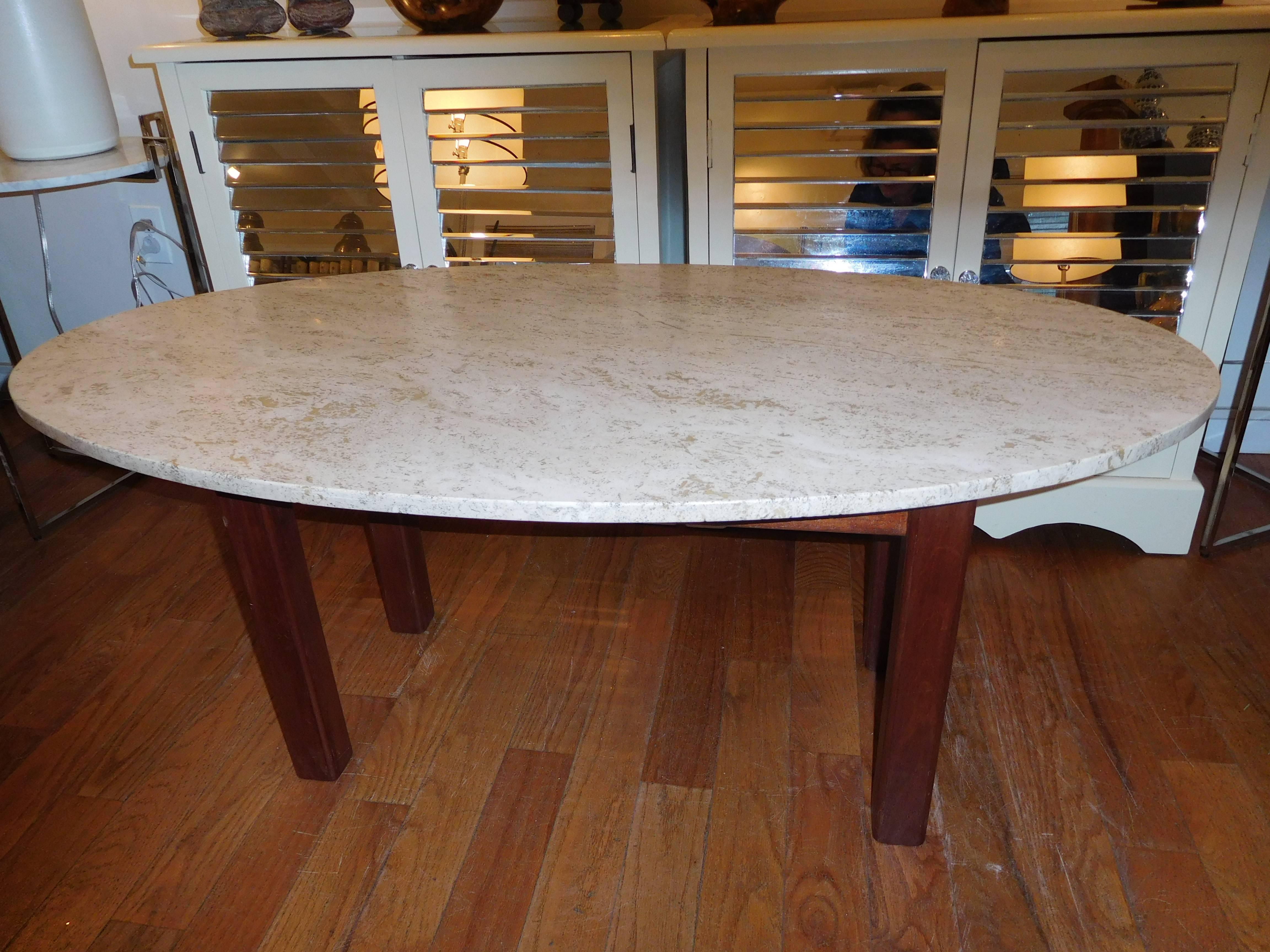 A 1950s travertine and wood handcrafted coffee table, simple clean lines, warm tones, and very functional.
     