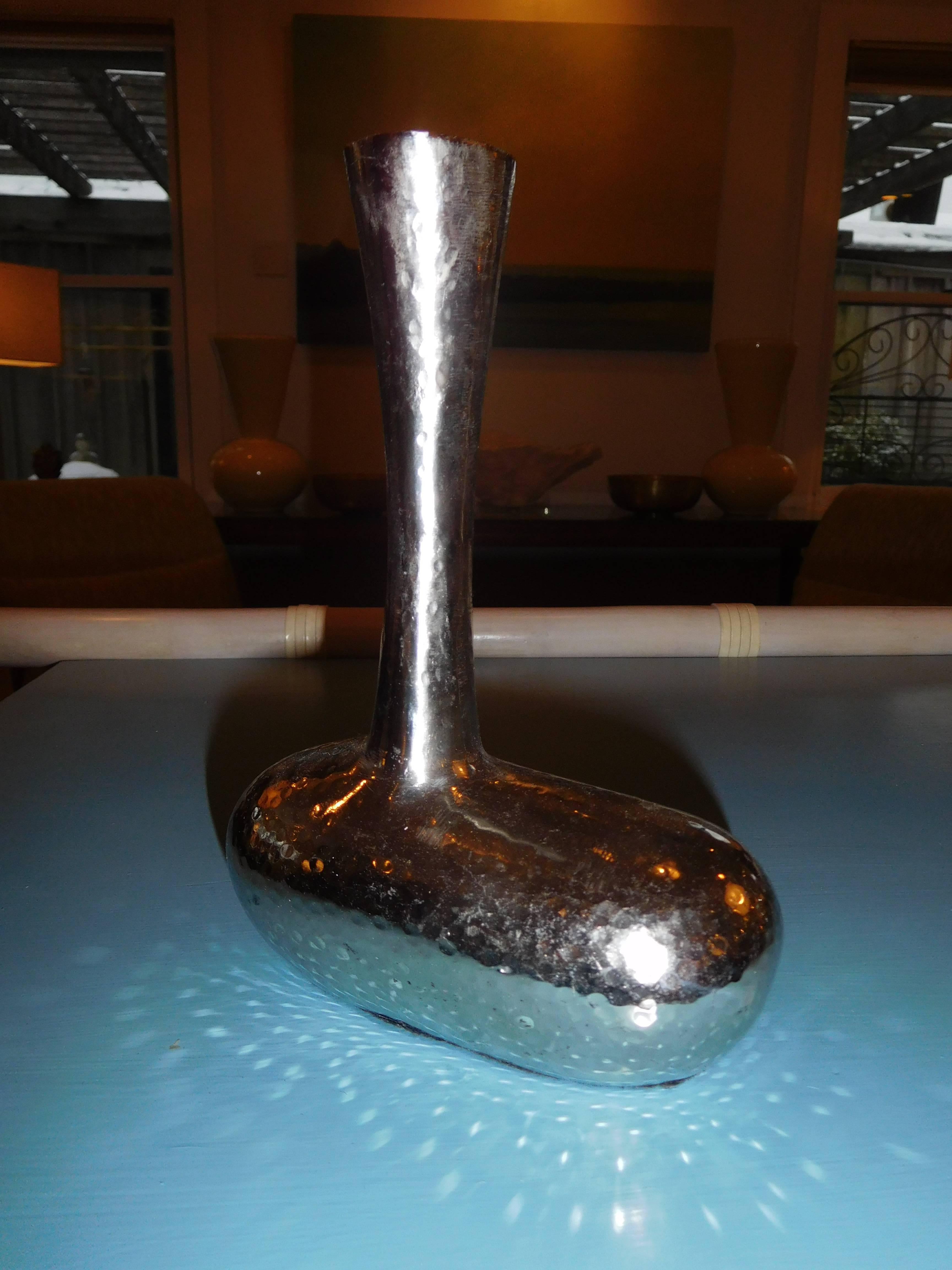 An unusual pair of hand-hammered chrome bookends, in the form of golf clubs.