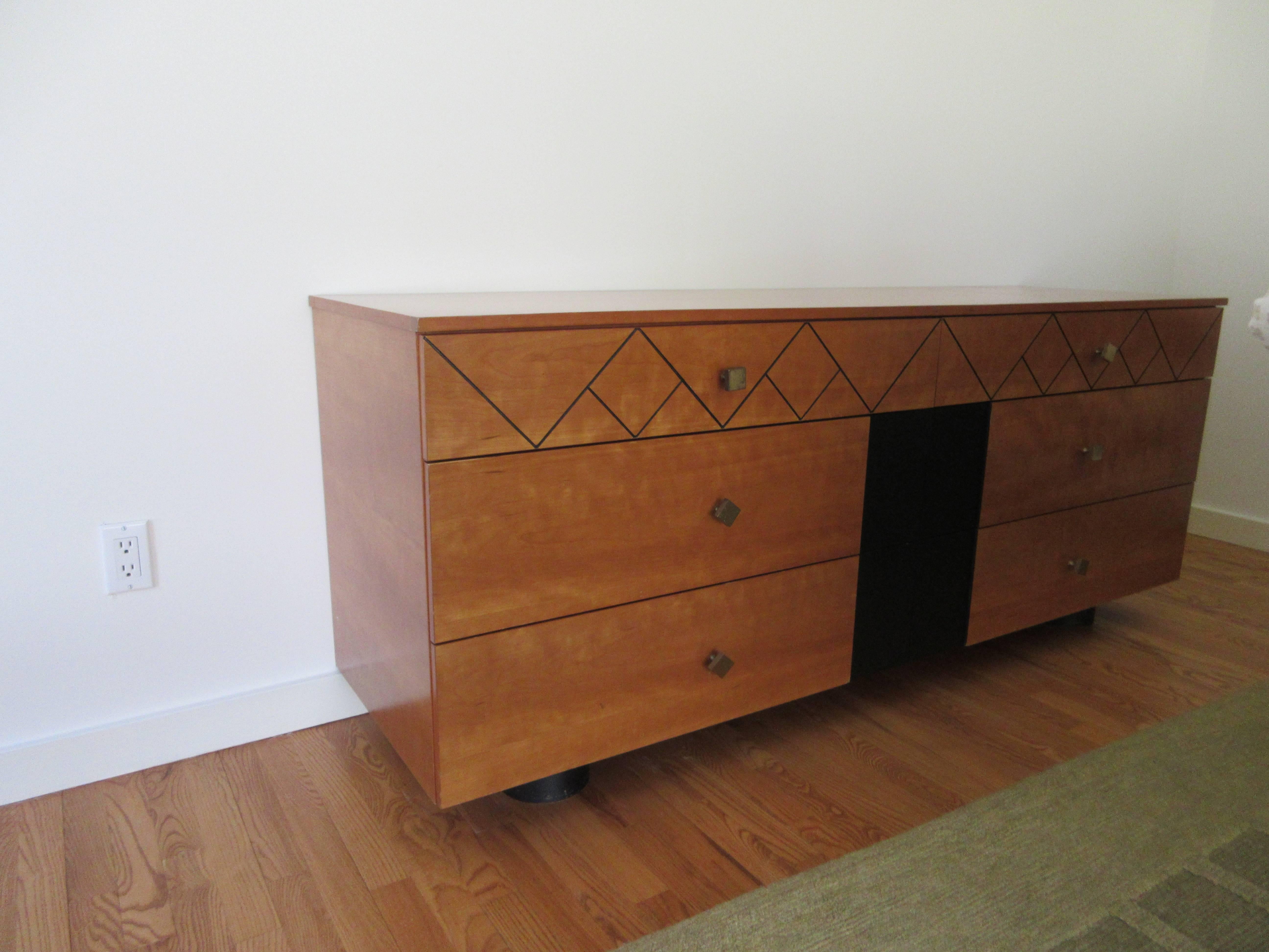 A Mid-Century Danish six-drawer dresser with six pull-out drawers. Brass diamond shape pulls. Ebony inlay diamond shapes on top drawers, with ebony ovate feet/base. Handsome burl woods with black middle panel, sharp custom piece.