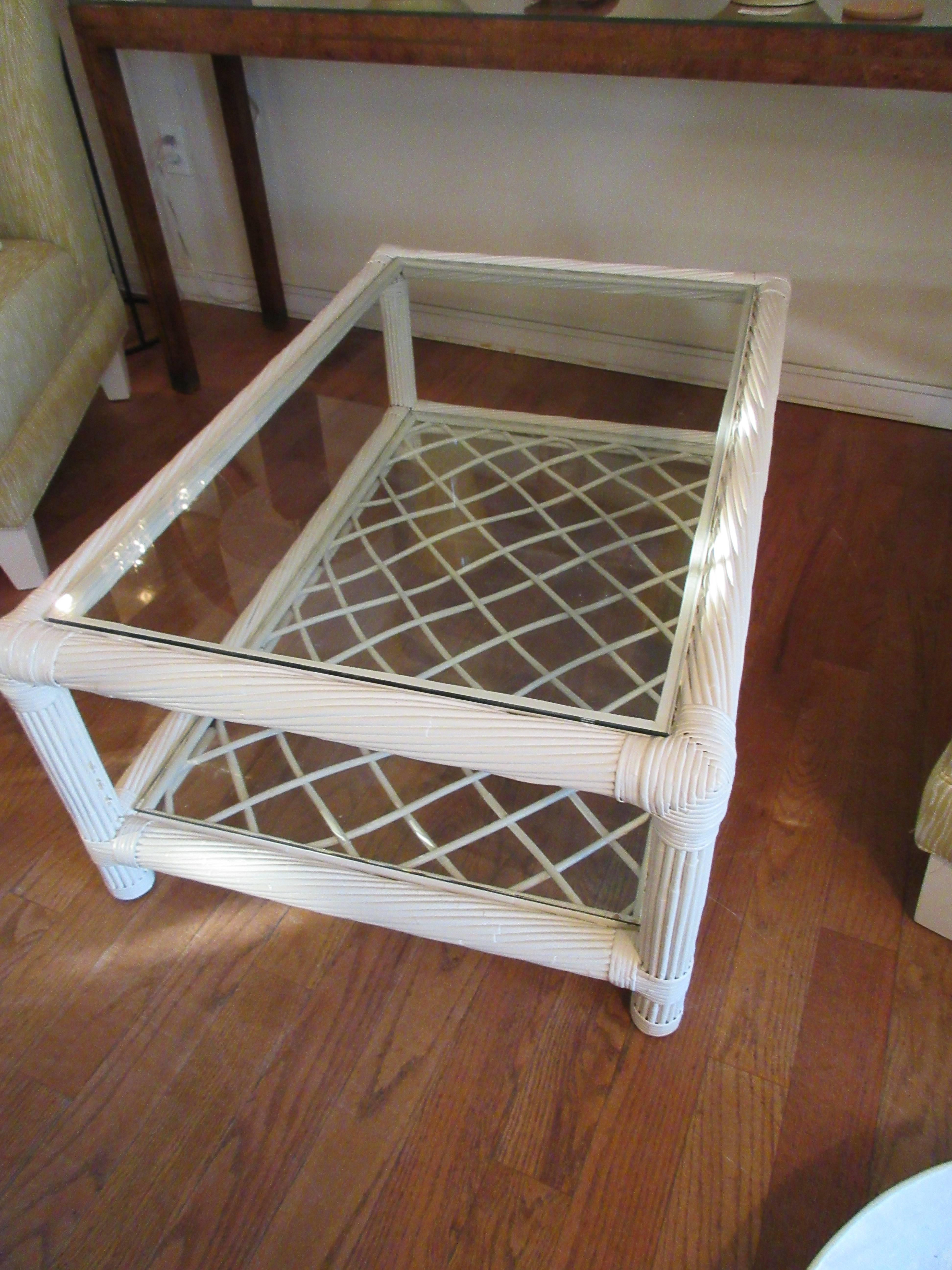 A Ficks reed painted bamboo coffee table. Two levels with glass inserts, lattice work on second level. Restored condition, painted in an oatmeal beige.
Excellent condition.