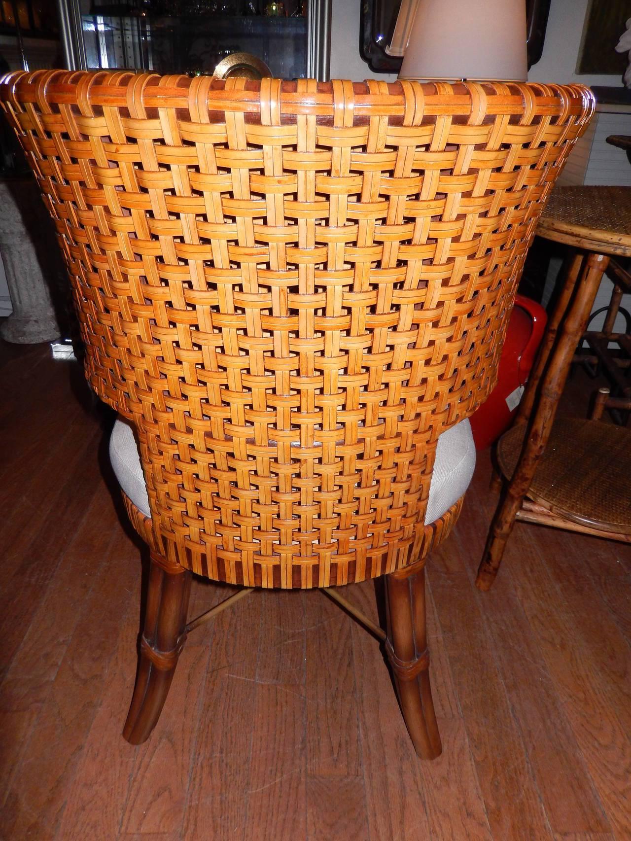 Pair of Danish modern handwoven leather chairs or dining room.
Cross bar bottom, curved back, linen upholstered seats.
Additional chairs available if required. Beautiful details, comfortable.