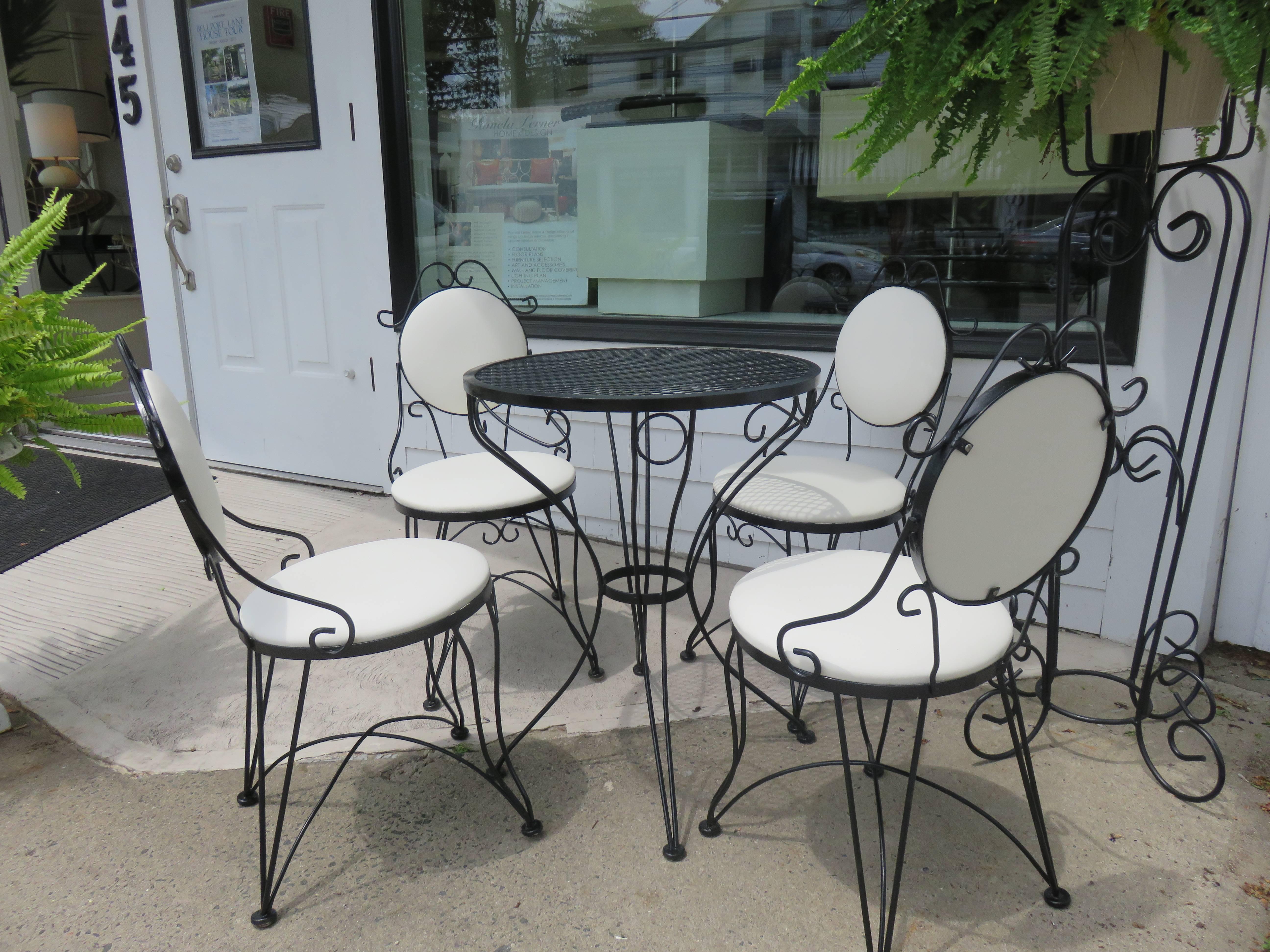 A Mid-Century Woodard bistro set.
Table and four chairs, Indoor outdoor.
The table measurements are H 28, D 24 inches.
The chair height is 33 inches.
Seat H 17 inches
Seat diameter 16 inches.
       