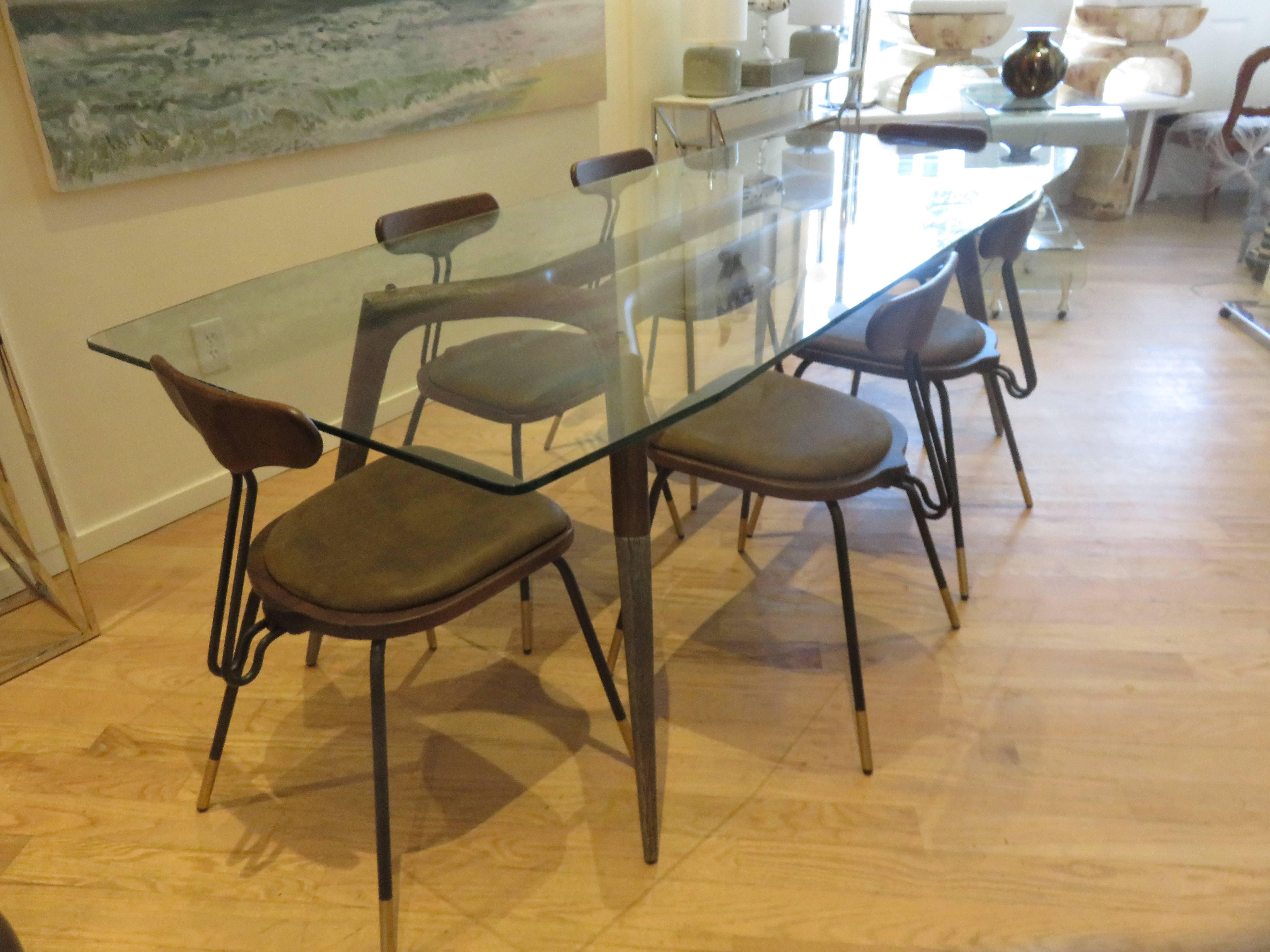 Walnut wood base with hammered steel to half of leg, half inch thick glass top,with cut angles on all four corners.
Six matched chairs with rich brown leather seats,premium quality Italian construction.The table can be sold separately,as with the