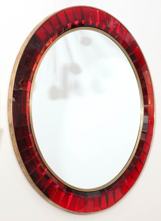 With its impressive scale and dazzling color, the mirror boasts a stunning elegance decorated with hand cut crystal by Ghiro designs. Ghiro designs creates unique pieces painstakingly hand cut and formed fusing the ancient craft tradition and modern