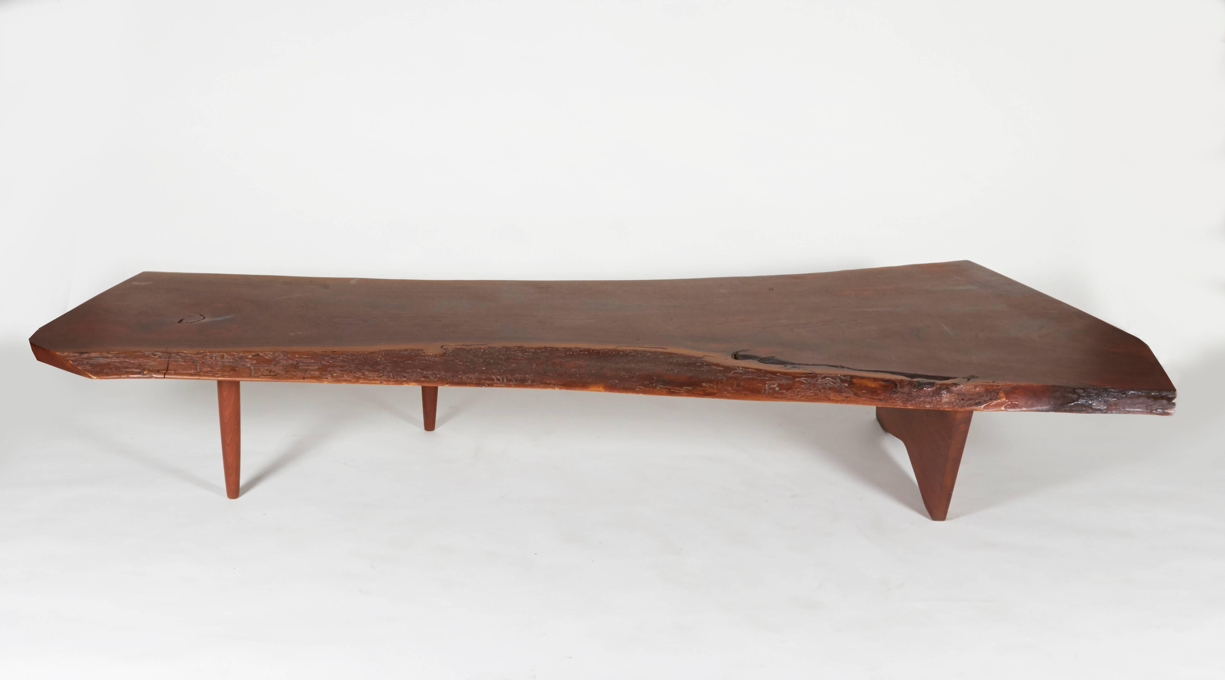 All of the wonderful qualities you expect from George Nakashima. It has an outstanding free edge form with beautiful irregularities in the grain.