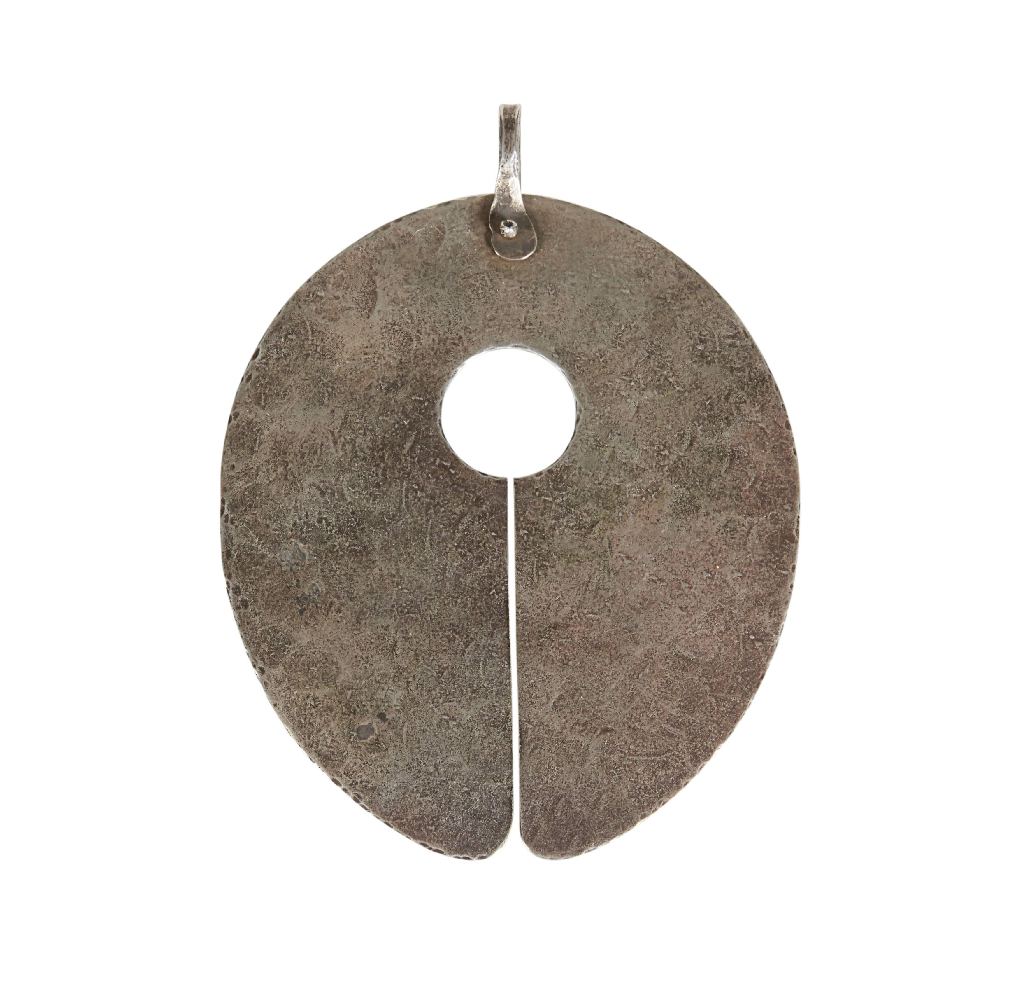 Hand-hammered and an unusually large size this gong styled pendant has an amazing presence. His jewelry is rare and coveted by collectors worldwide. This extraordinary piece would be the highlight of any collection.