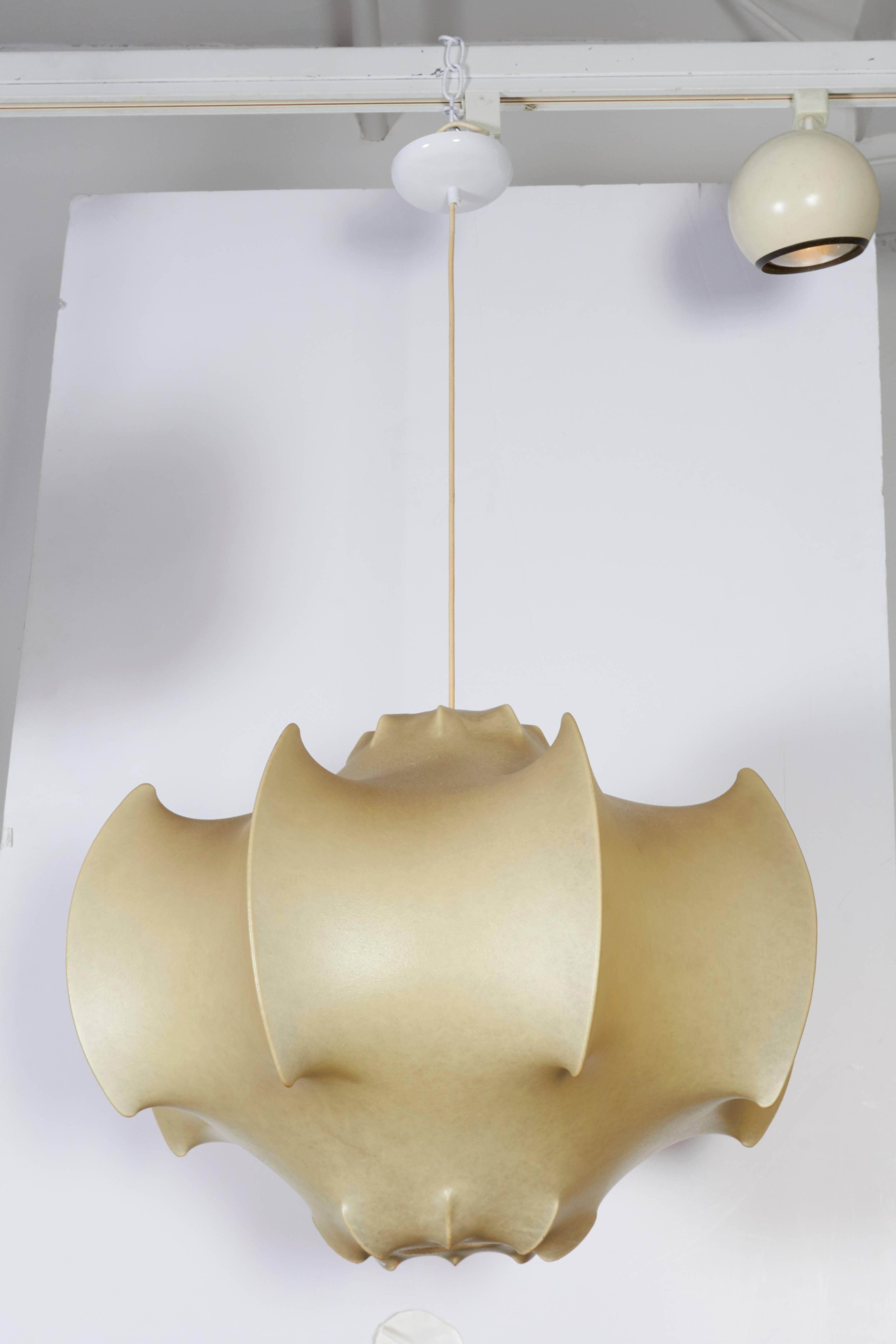 An icon of Italian lighting and a unique process to produce. Several layers of resin are sprayed on a wire frame to create the sculptural form that diffuses the light.