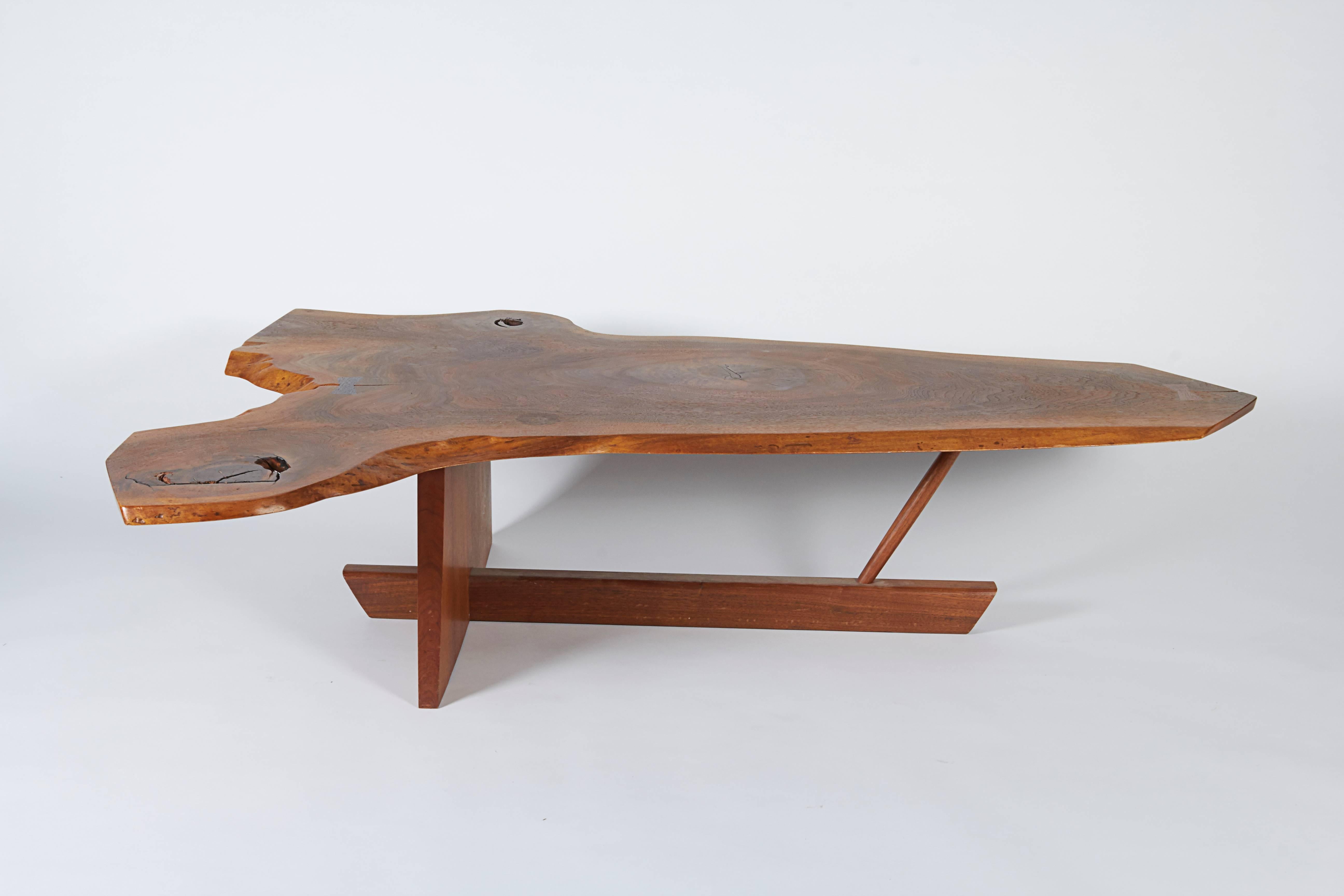A classic example of Nakashima taking an extraordinarily beautiful slab of wood and turning it into an outstanding piece of furniture. There are two butterflies and incredibly interesting irregularities in the grain. Signed and dated by George