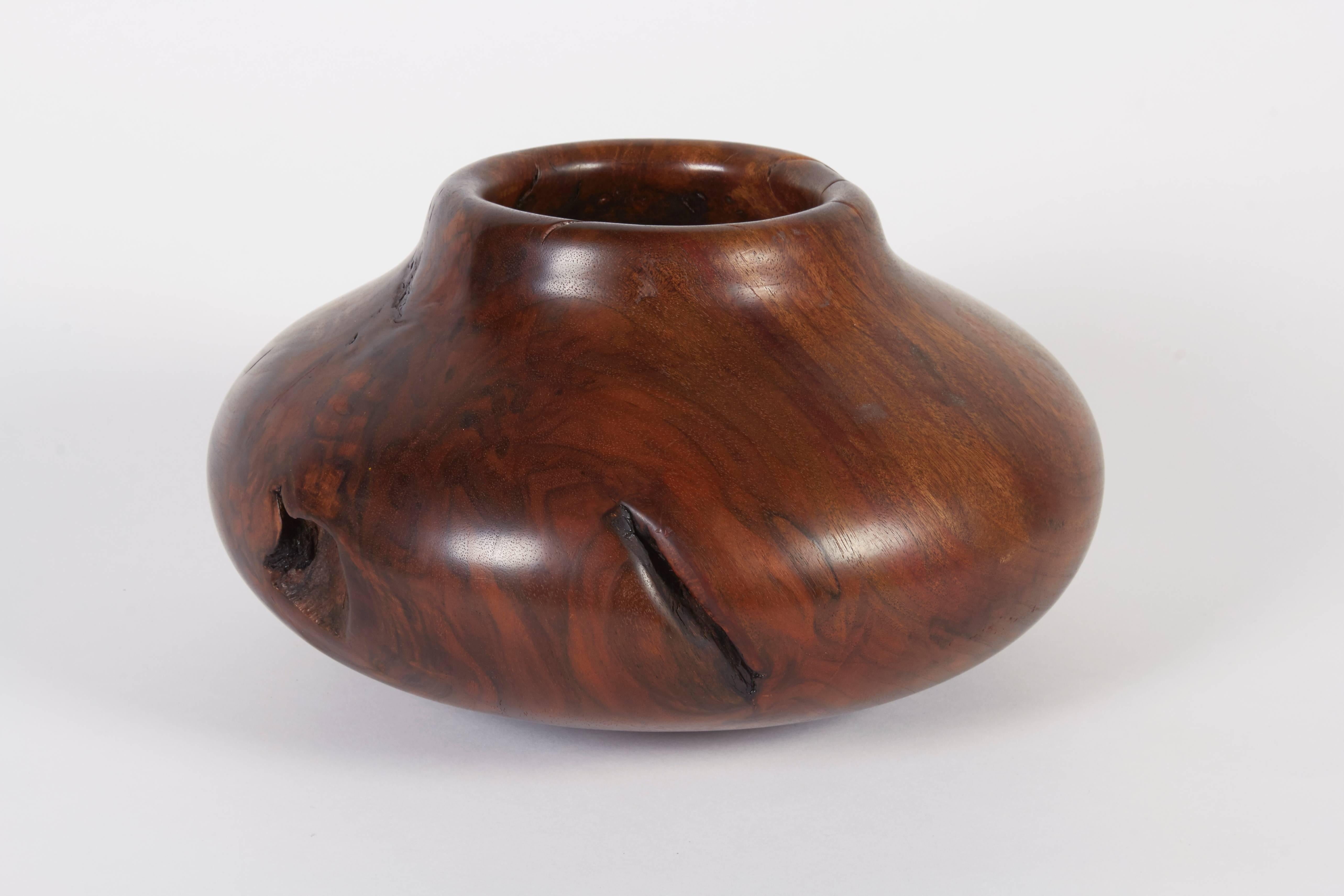 Melvin Lindquist began turning in the 1930s as a vertical turret lathe operator for the General Electric Company. In his shop at home, he began an exploration of the vase form through woodturning which has continued for over fifty years. He was one