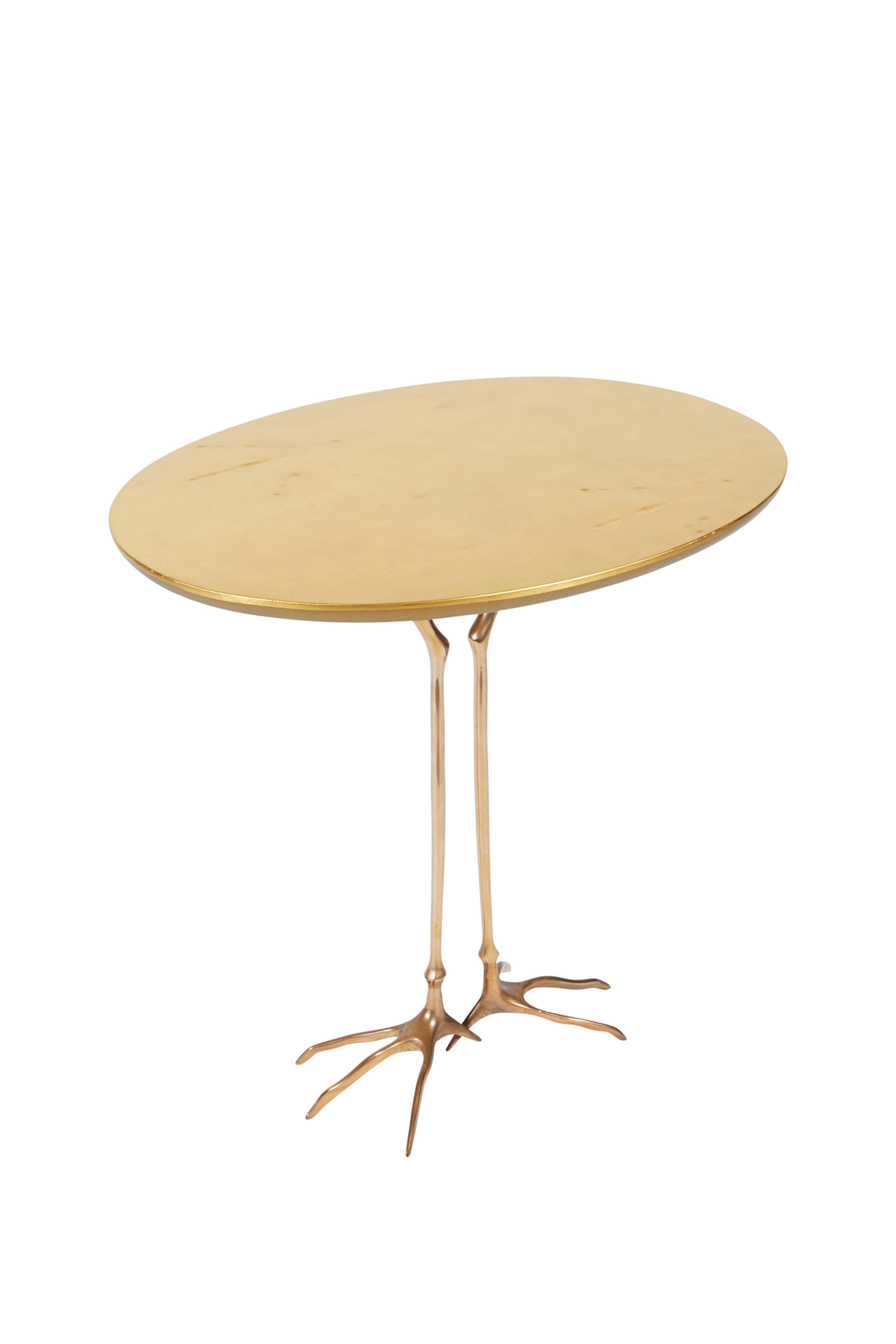 An outstanding and well documented reproduction of the Classic Meret Oppenheim Traccia table. This latter model has the addition of the subtle tracks embossed into the gold leaf top.