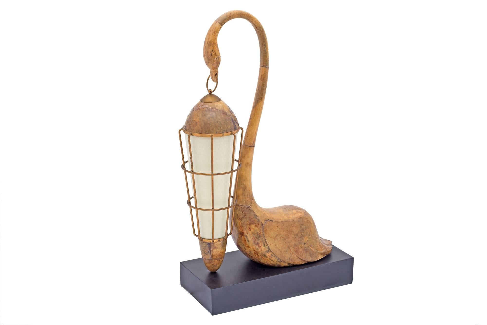 Tura's work at times takes on a quality of functional art. This lamp is no exception having a beautiful sculptural form. The parchment lamp diffuser creates a warm pleasing glow.