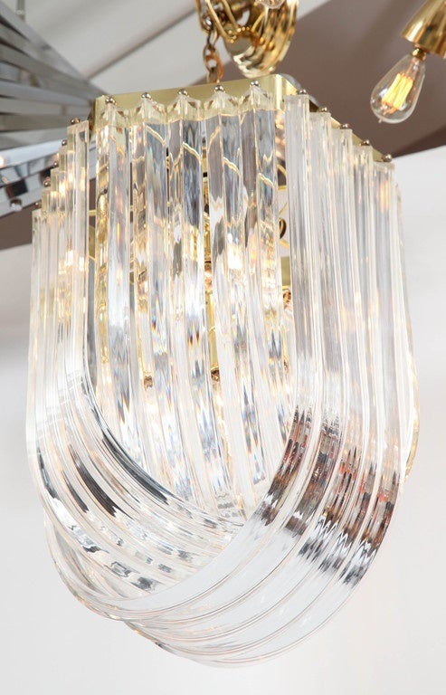 Decorative Lucite chandelier with brass details, Italy, circa 1950.