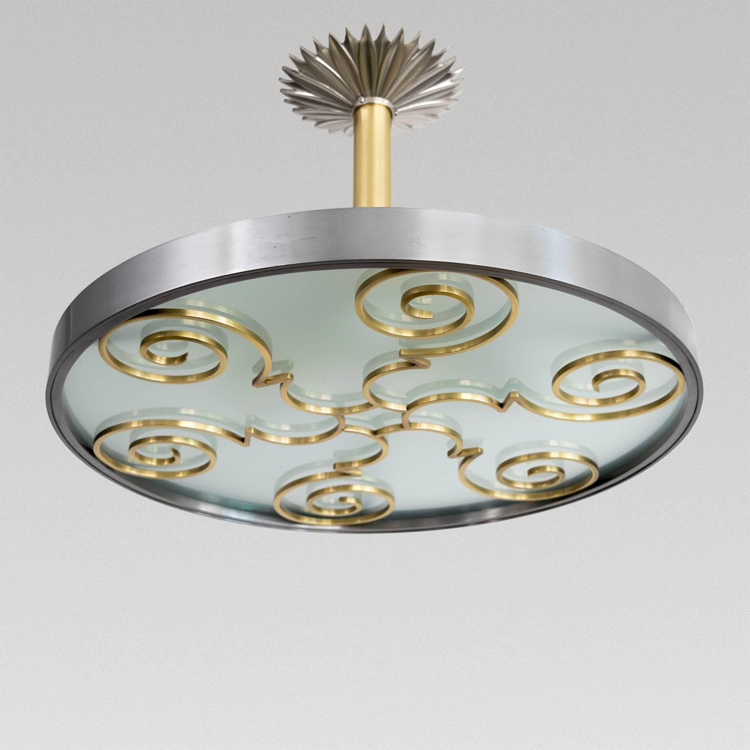 Scandinavian Modern light fixture in polished steel, brass and glass by Lars Holmstrom, Sweden, circa 1930-1940. Made at Holmström's Arvika Studio with impressed marks. Newly rewired with three standard base sockets.
