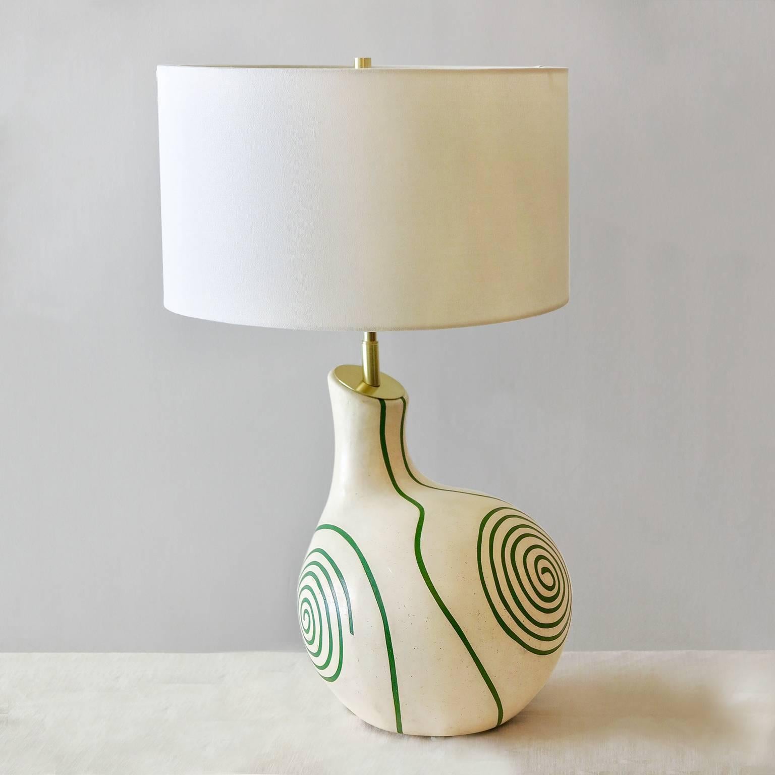 Midcentury French ceramic table lamp with hand-painted and carved colored swirl design on off-white background, France, circa 1950. Newly electrified with 2 sockets.