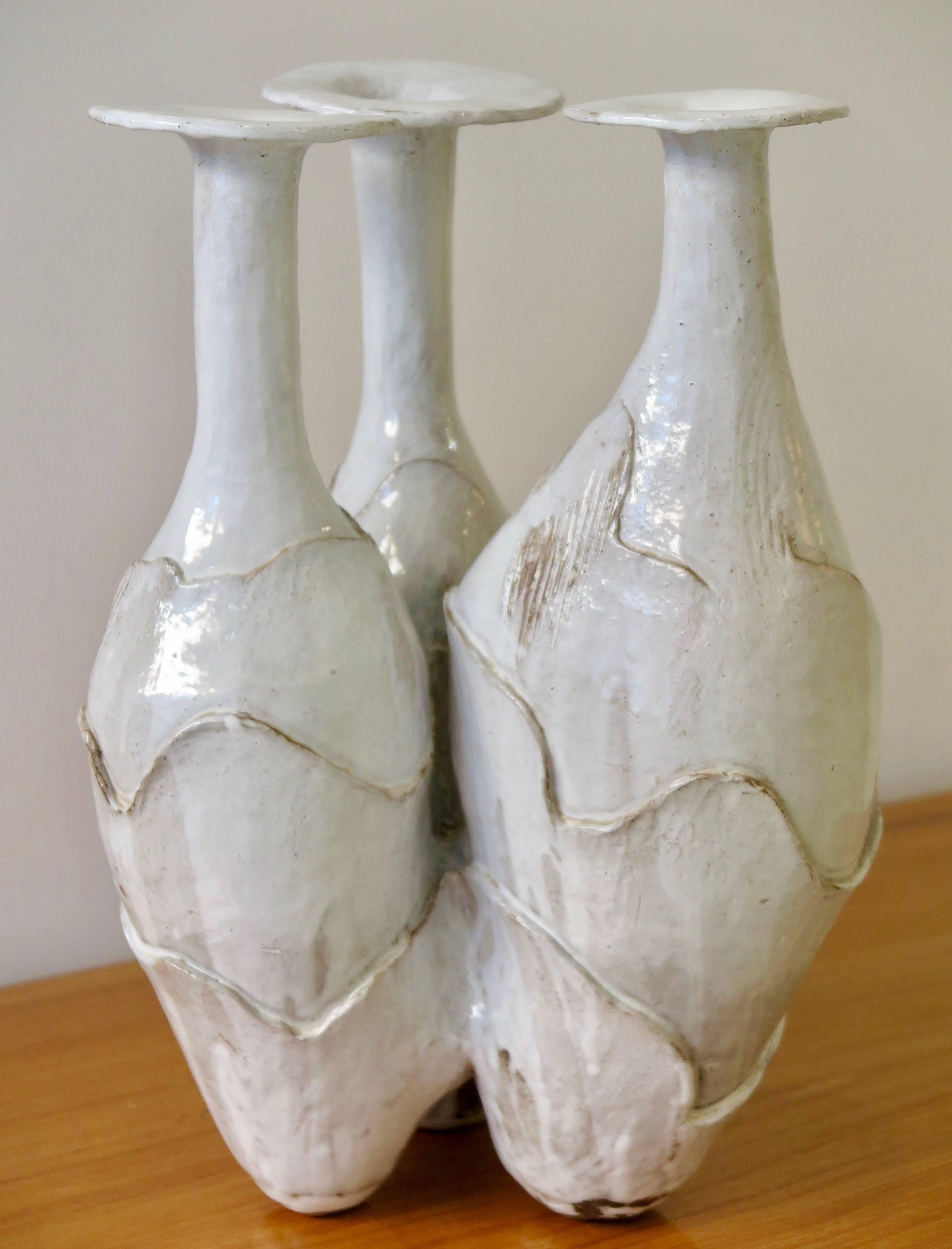 Biomorphic glazed ceramic vase in deep milky white shades with three attached vases.