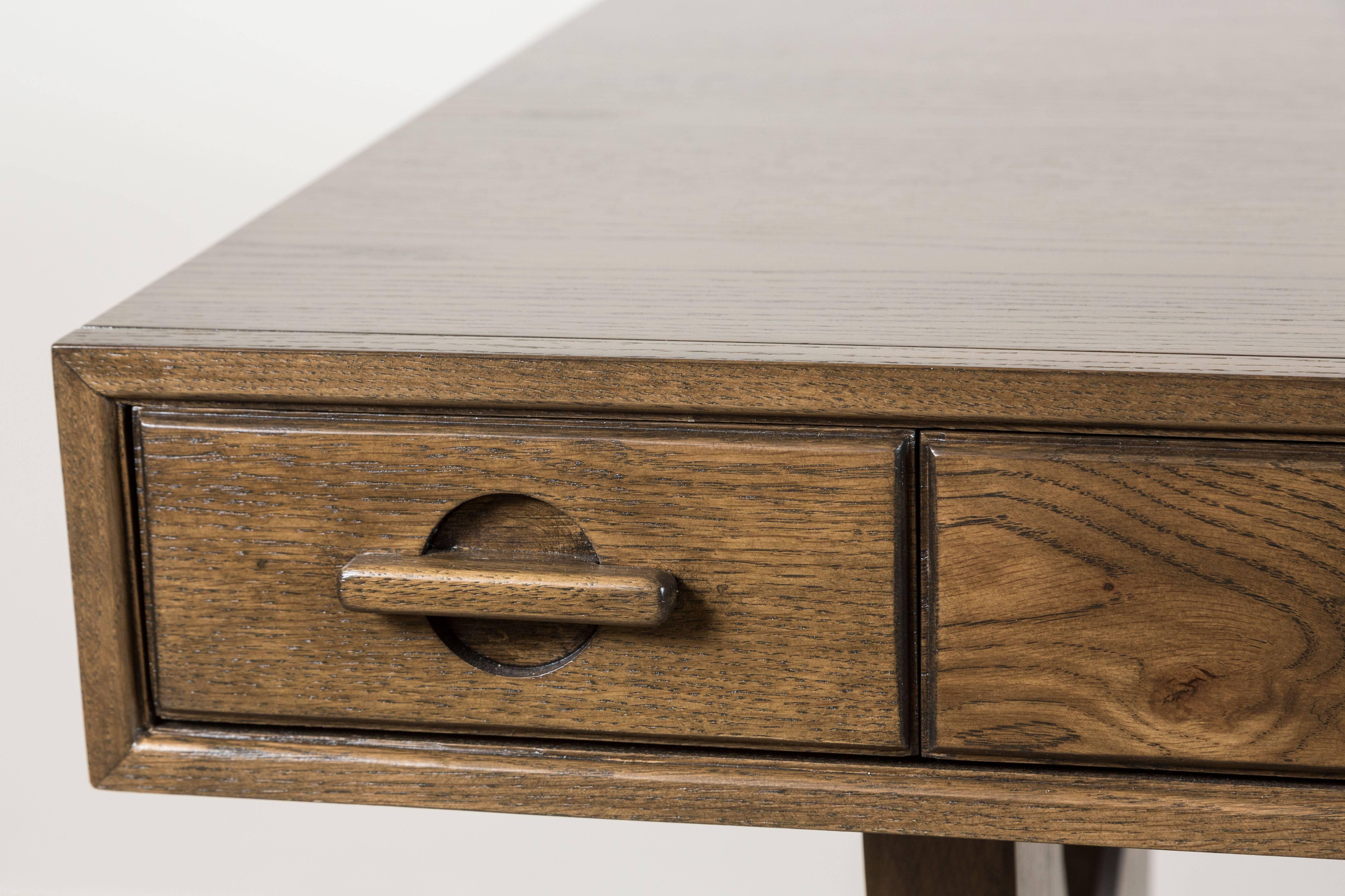 The Ojai desk has four drawers and features solid American walnut or white oak trestle legs. The drawer handles are made of solid carved wood. Shown here in Light Greywashed Oak. Available finishes may vary. 

The Lawson-Fenning Collection is