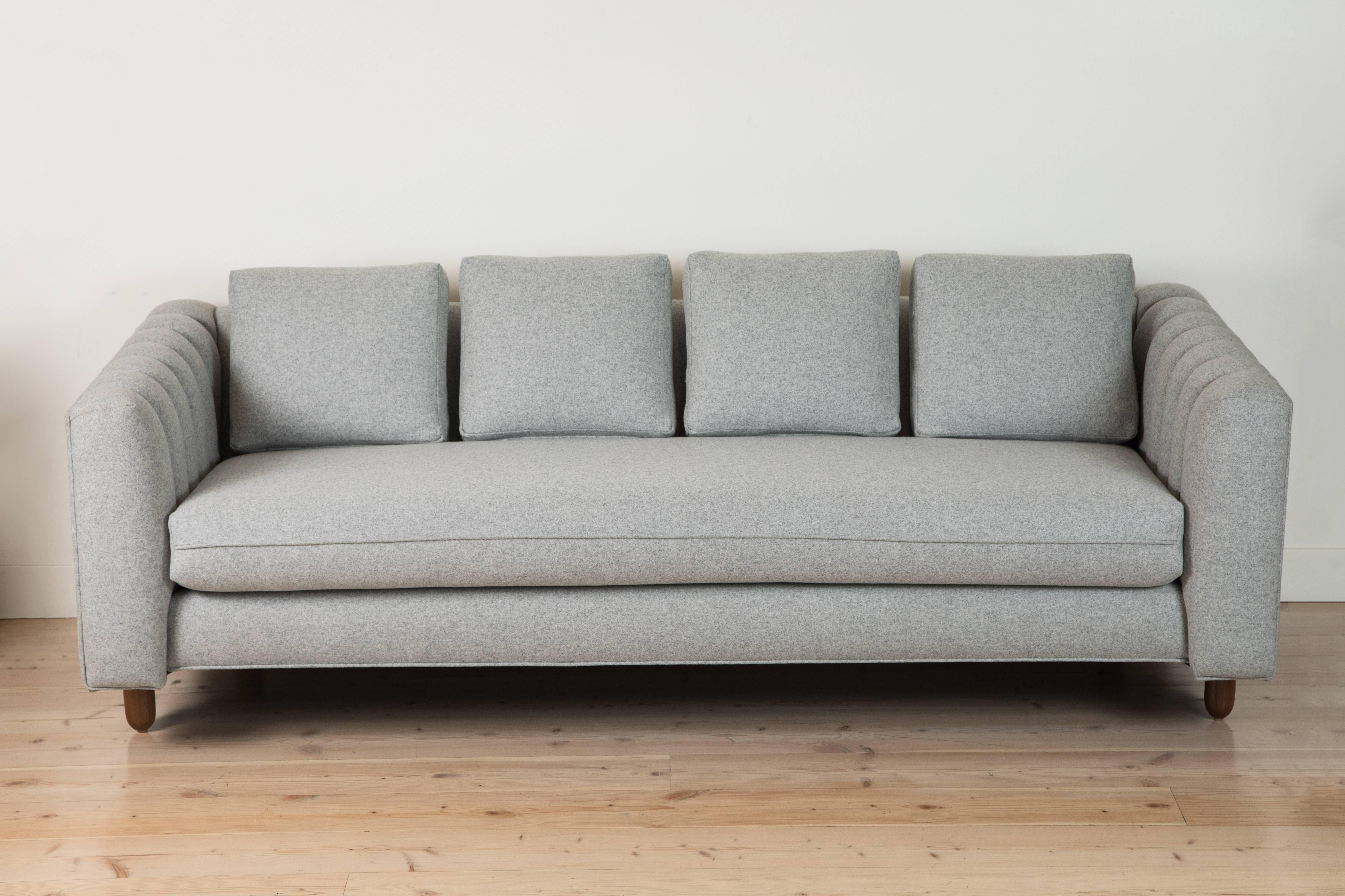 The Isherwood Sofa features a channel tufted body with loose bolster cushions. The turned legs are made of solid white oak or American walnut and are inset on the sides revealing the leg detail.

Also available in Customer's Own Material with a 6-8