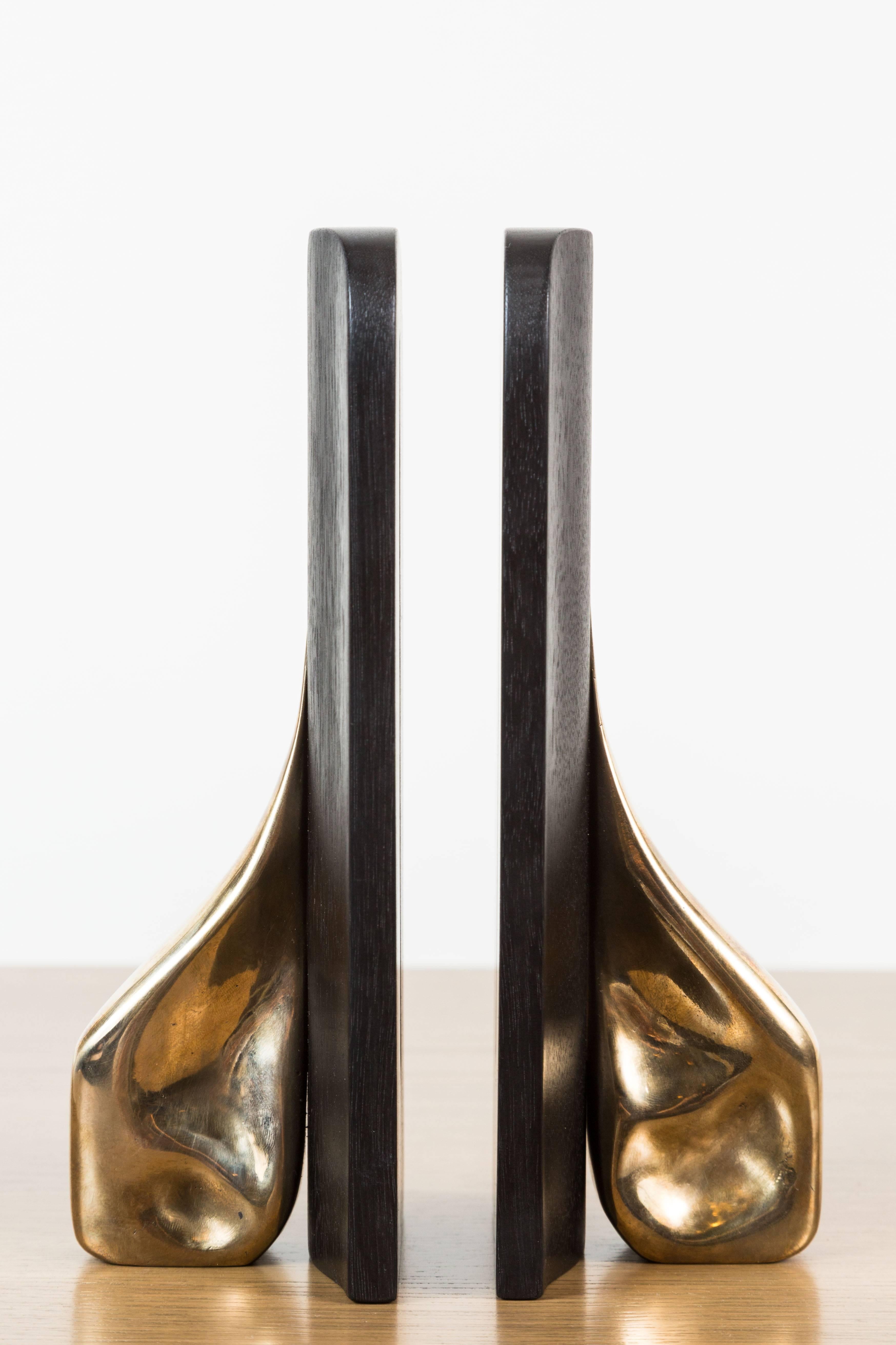 Pair of Ebonized Walnut and Cast Bronze Bookends by artist Vincent Pocsik in collaboration with Lawson-Fenning. Made of natural materials, this decorative object can be accessorized on table top, book shelf, or desk to achieve an organic modern
