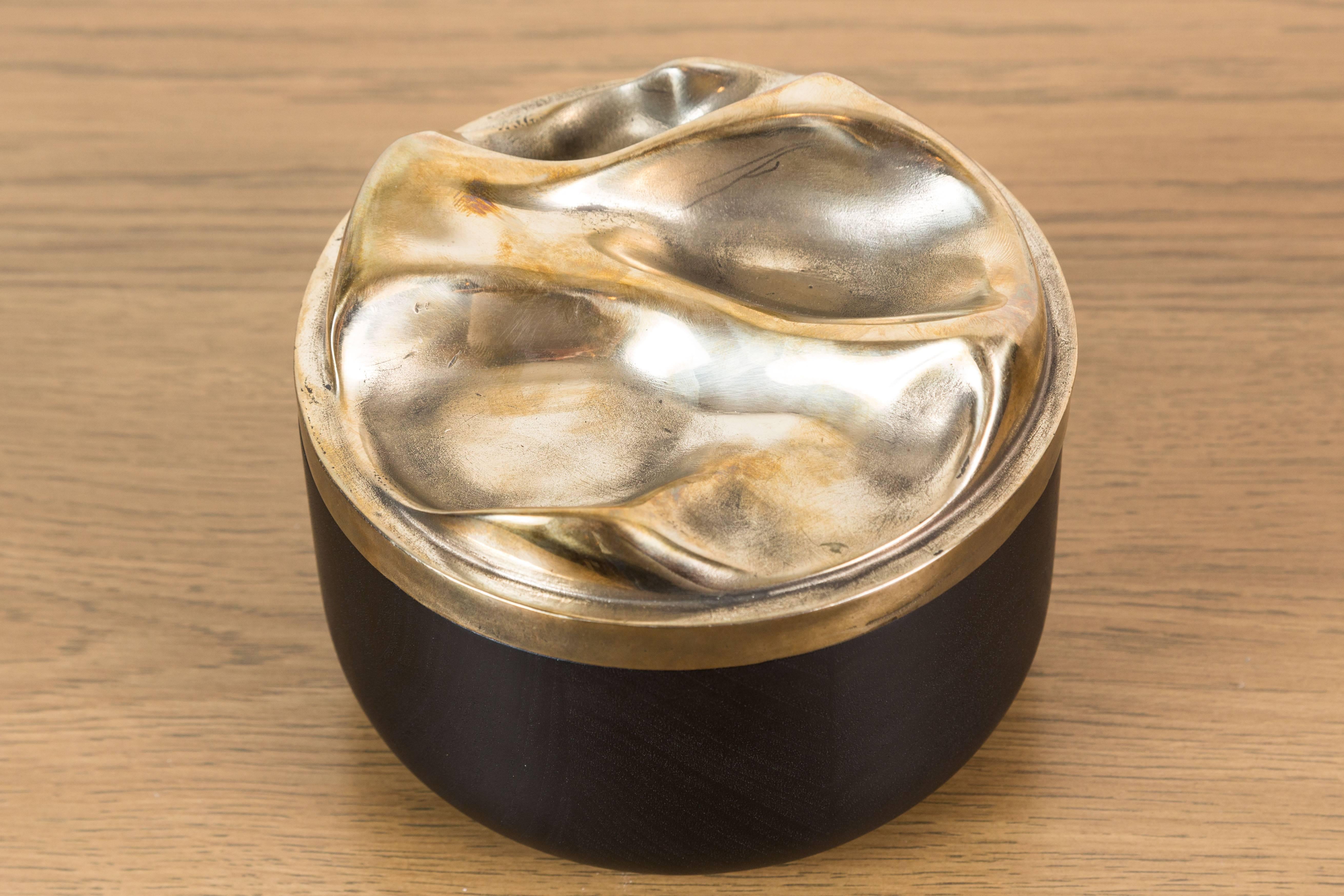 Ebonized Walnut and Cast Bronze Round Box by artist Vincent Pocsik in collaboration with Lawson-Fenning. Features a sculptural carved wood interior. Made of natural materials, this decorative object can be accessorized on table top, book shelf, or