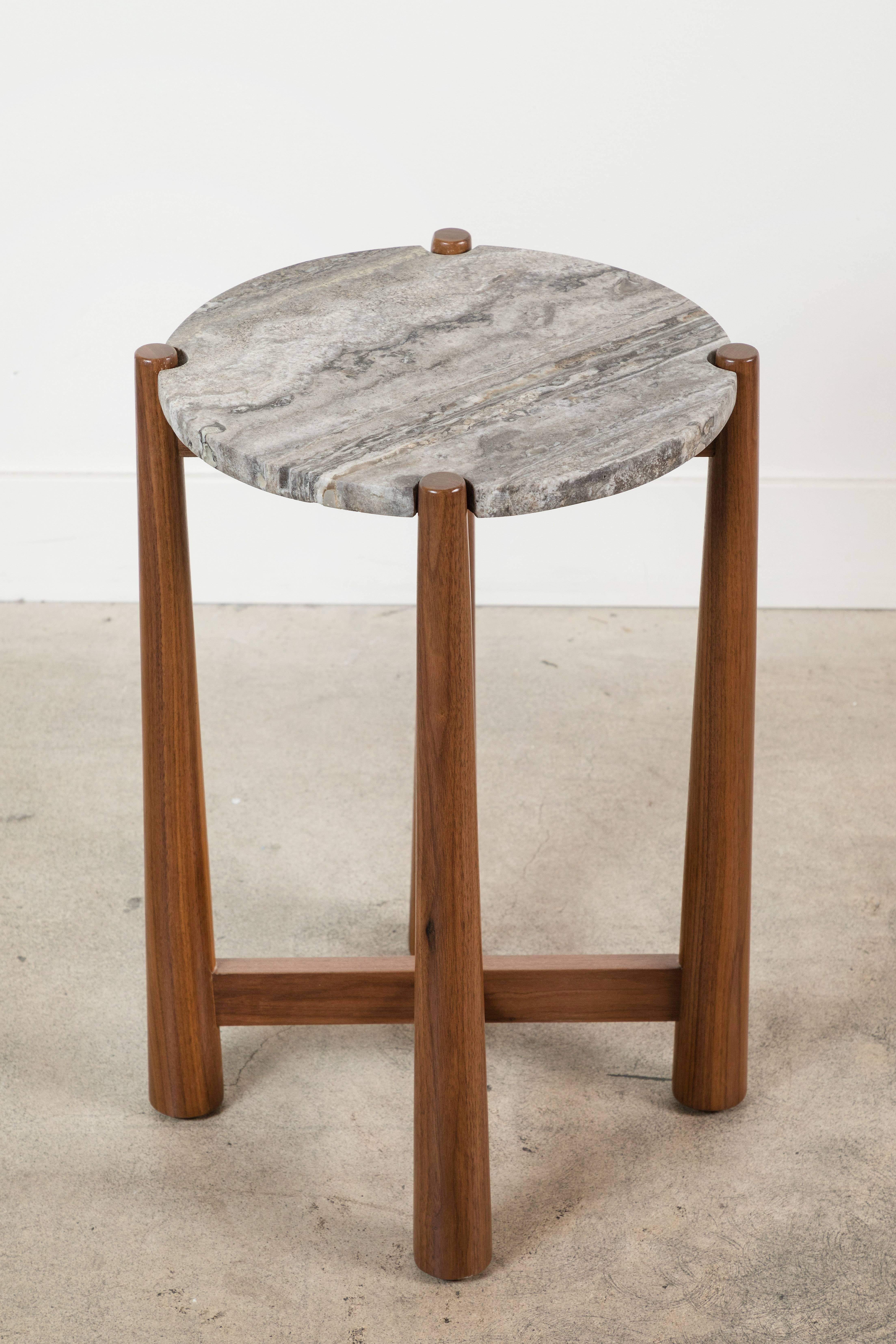 The Bronson Drinks Table features a round stone top with notched corners that rest atop a detailed walnut or oak base. Shown here in Titanium Travertine and Light Walnut.

The Lawson-Fenning Collection is designed and handmade in Los Angeles,