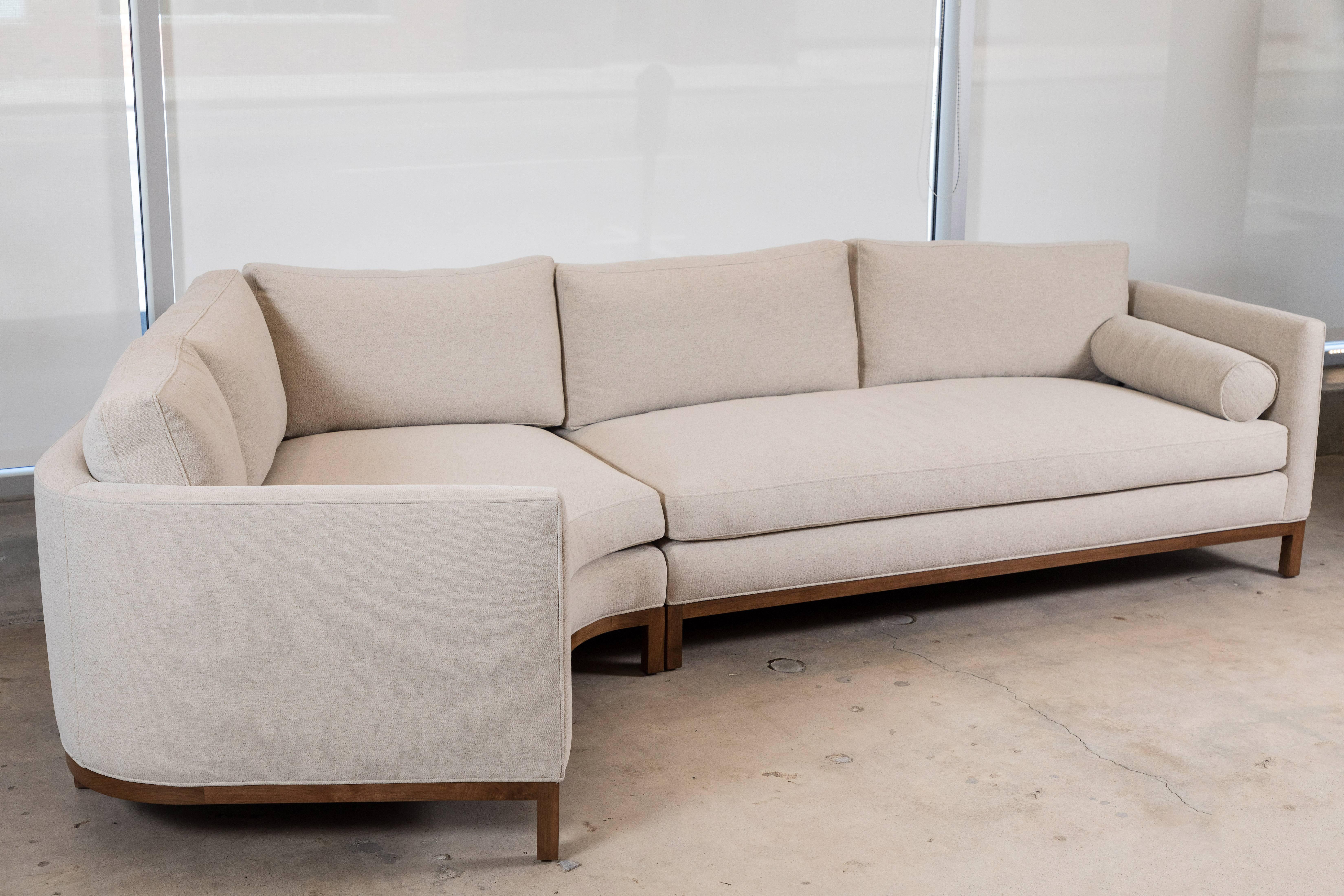 The Curved Back Sectional is a tuxedo style sofa with curved back corners and features down-wrapped, removable seat and back cushions and two bolsters. Can be made with a White Oak, American Walnut, or metal base.

Available to order in customer's