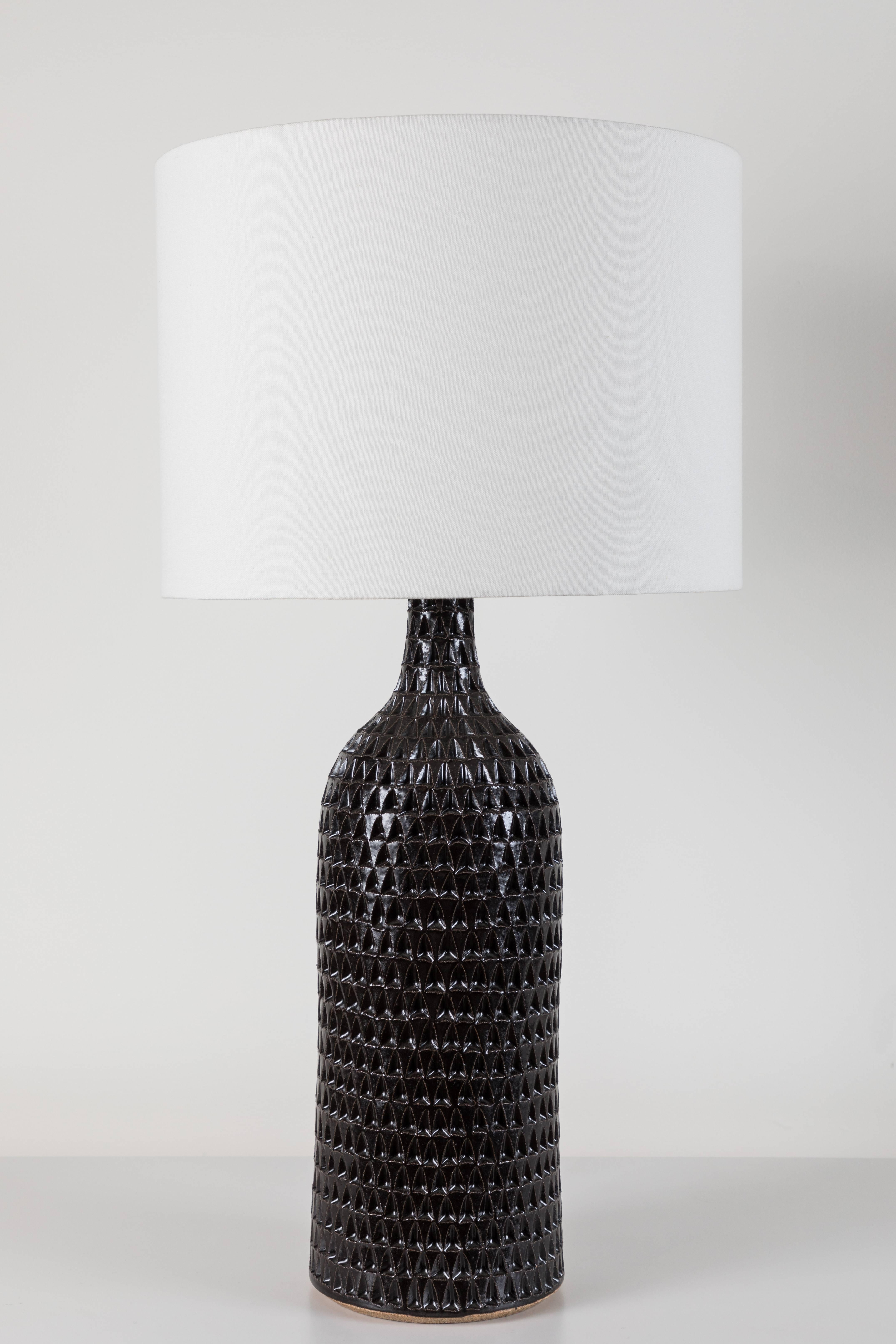 Pair of extra large black carved bottle lamps by Victoria Morris.