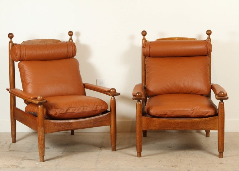 Pair of oak and leather armchairs by Guillerme et Chambron