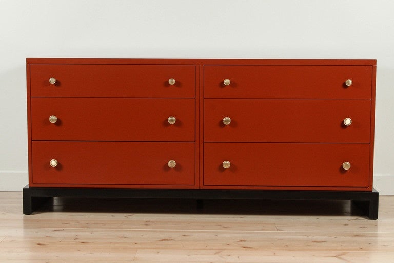 Stunning orange lacquered dresser by Widdicomb from their popular Flexi-Unit line. Features 6 drawers with brass hardware and an ebonized walnut base.